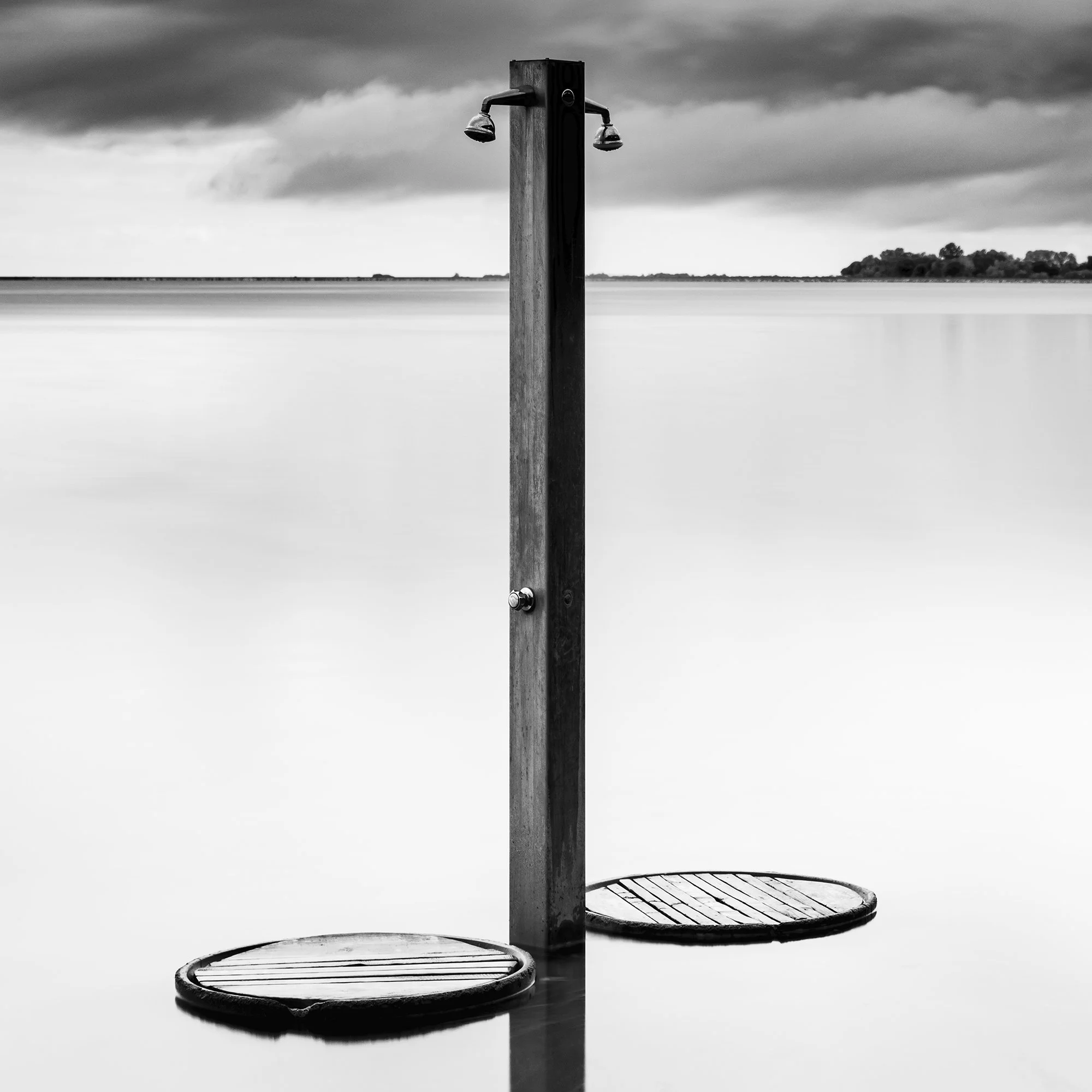 Close-up of Beach Shower in a Storm – black-and-white fine art photograph of a beach shower beneath dramatic clouds by Gerald Berghammer.