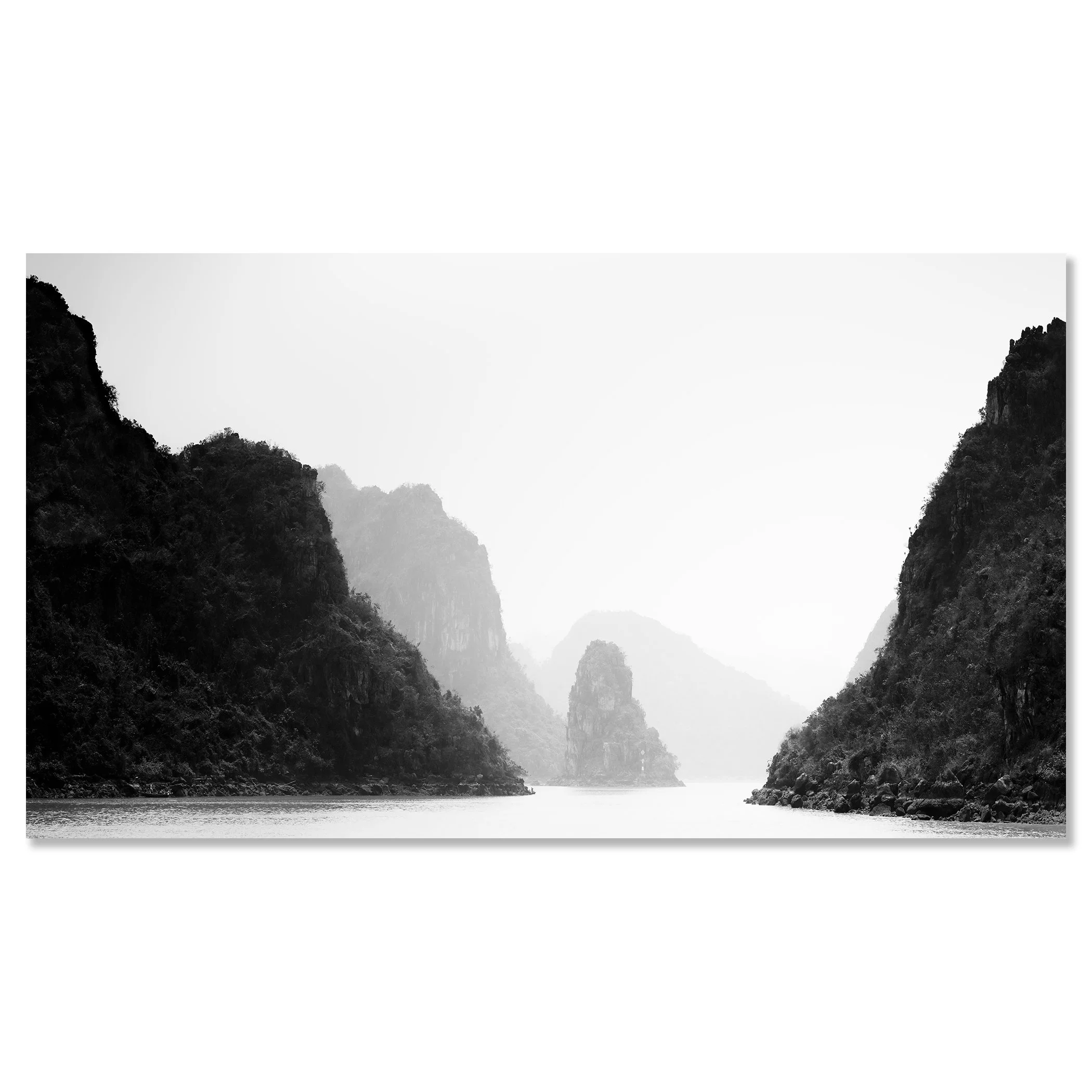 Black-and-white photo of calm water between steep limestone cliffs with misty mountains in the background – dibond frameless