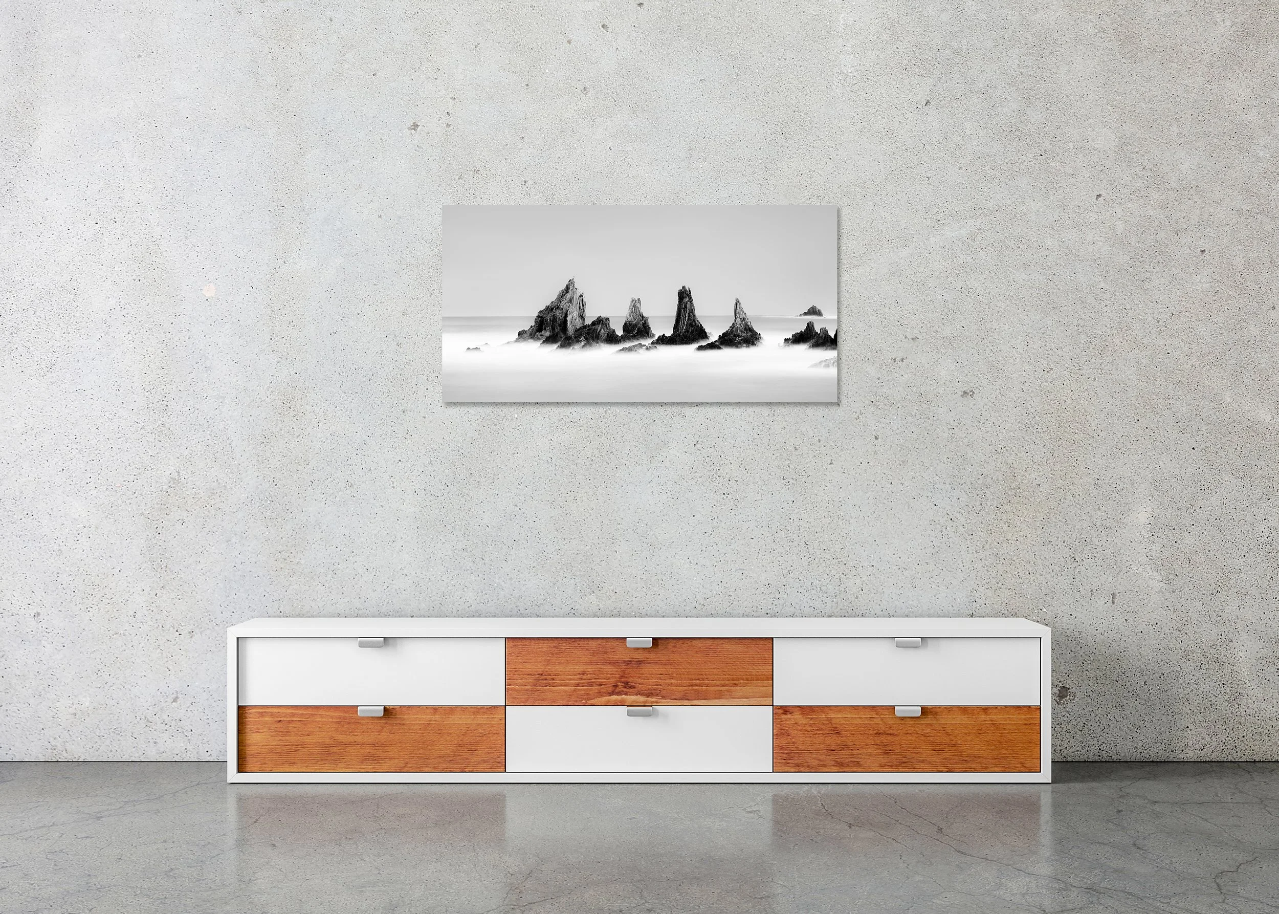 Rocky Peaks Panorama, Study 2 displayed above a low cabinet as a frameless black-and-white aluminium Dibond print by Gerald Berghammer.