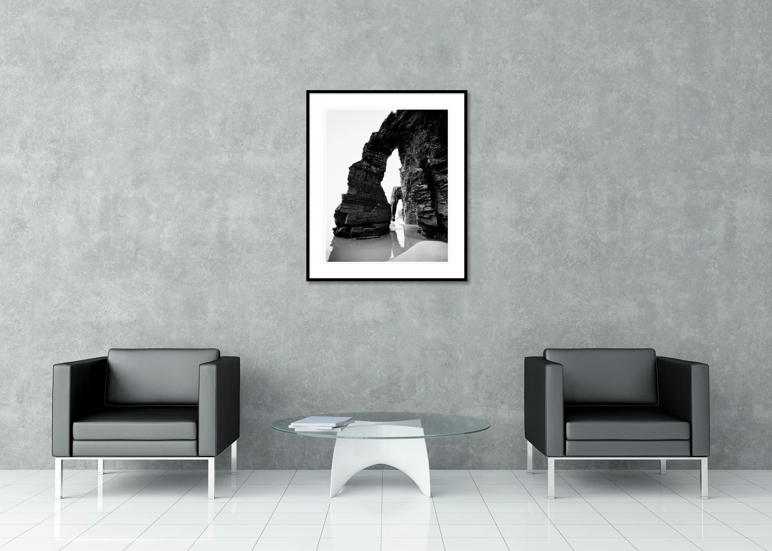 Minimalist black and white long-exposure seascape of a rock arch formation with wet sand reflections, archival pigment print in classic frame with passe-partout.