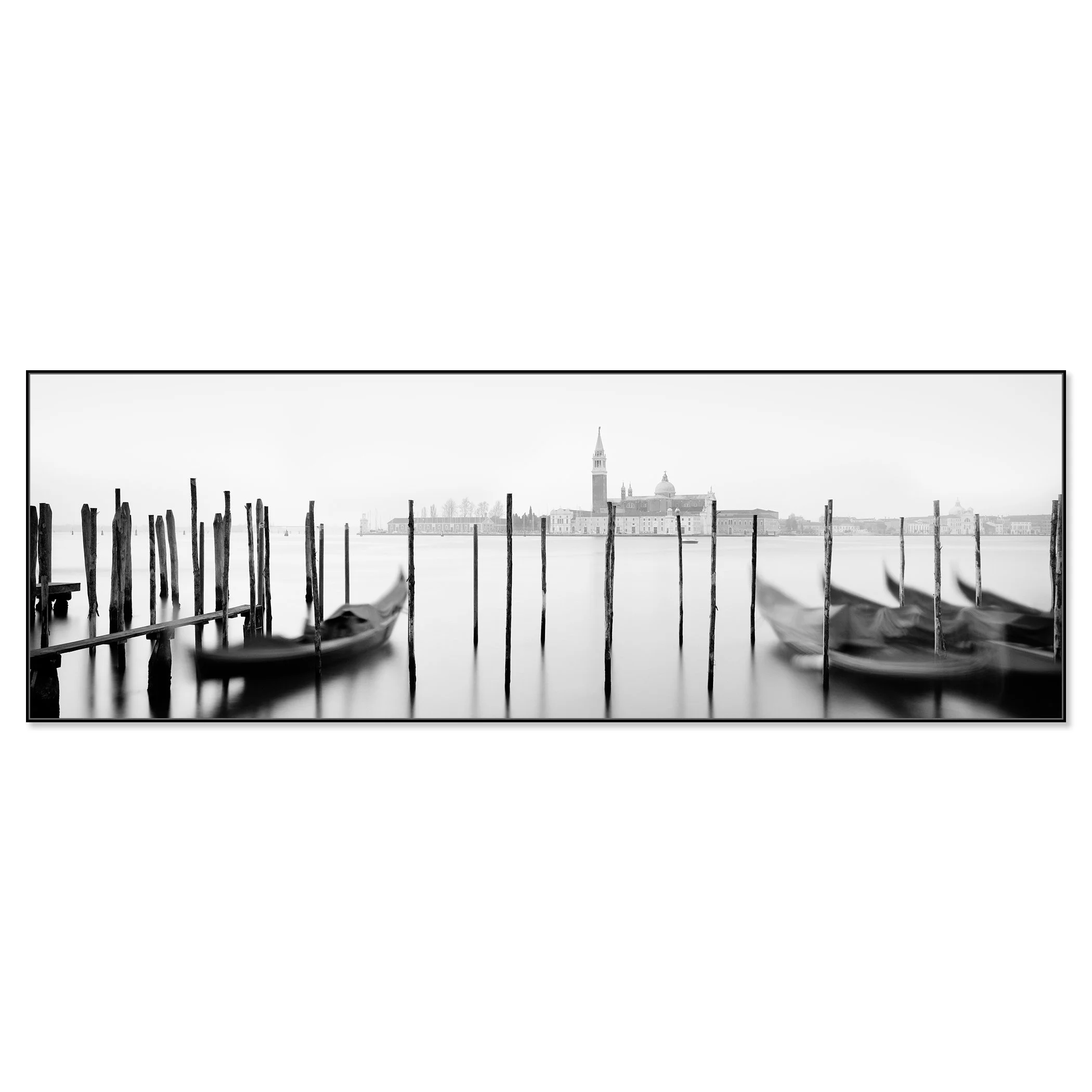 Gerald Berghammer - Black and white cityscape photography. Gondolas moored along wooden posts on a canal with view of a city skyline and a tall bell tower. Chromaluxe framed black