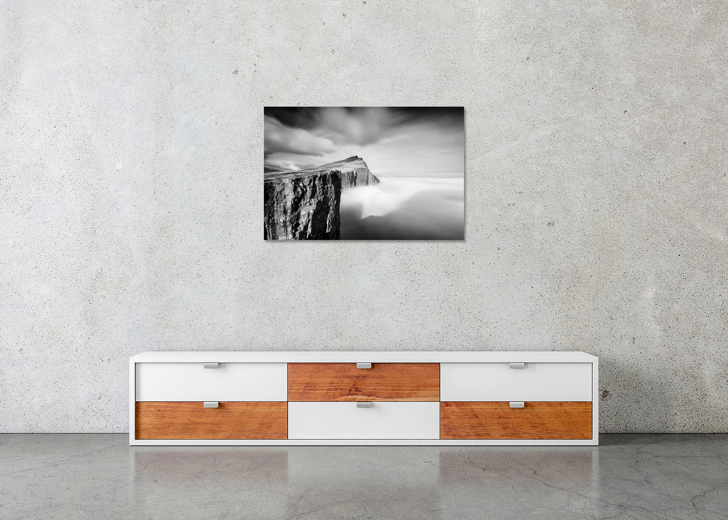 Foggy Slave Cliff, Study 1 – Faroe Islands, frameless black-and-white photograph on aluminium Dibond displayed in a minimalist interior. Photo by Gerald Berghammer.