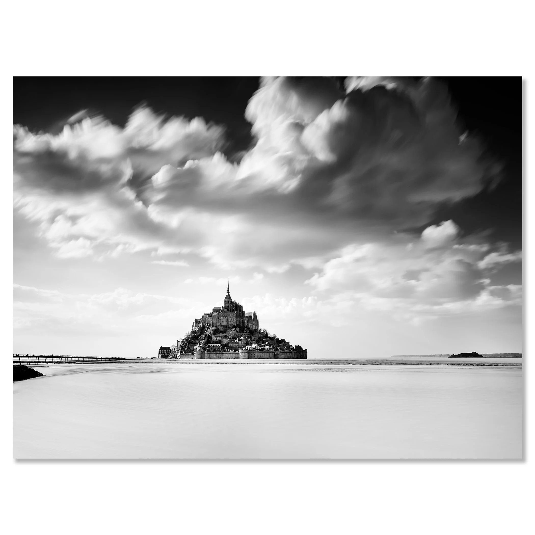 © 2023 Gerald Berghammer - B&W photography. Mont Saint-Michel, a historic island with a tall spire and medieval architecture, surrounded by water and clouds. Chromaluxe frameless