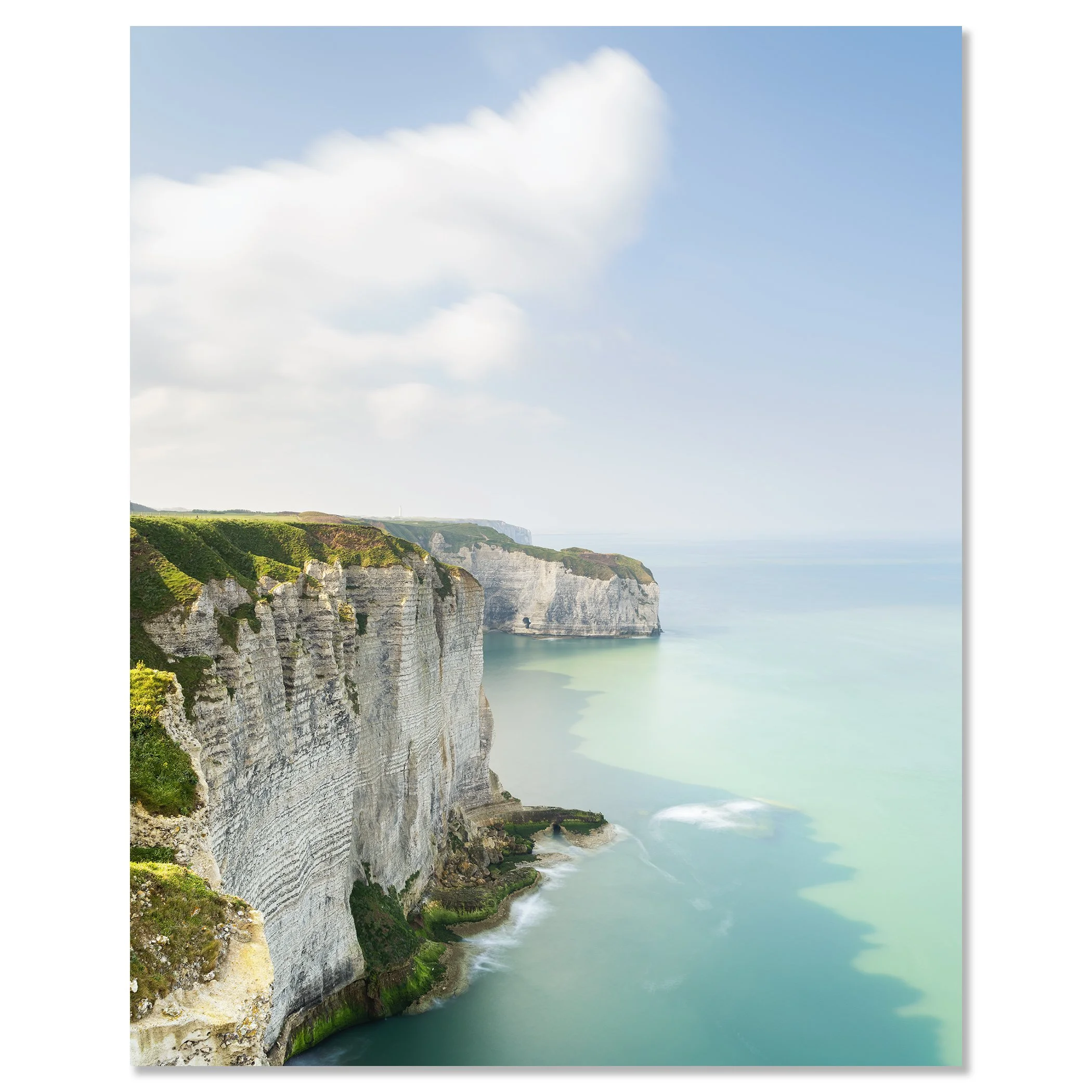 Gerald Berghammer - Color Photography. Cliffs along a coastline with green vegetation, white rock formations, and a calm sea under a partly cloudy sky. Chromaluxe frameless