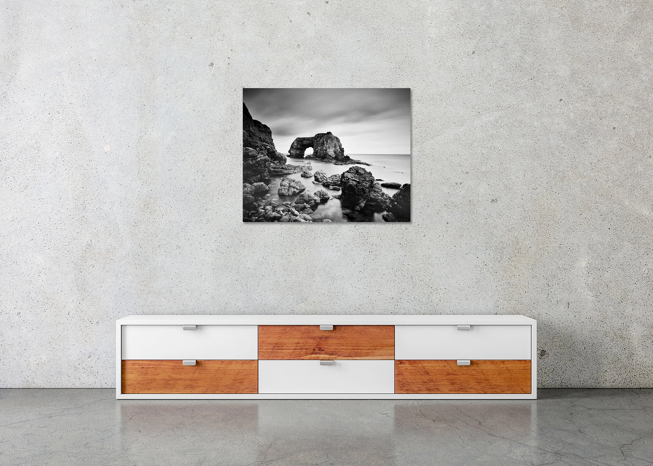 Monochrome photo print of Great Pollet Sea Arch with dramatic rock formations and still ocean water, mounted to Dibond, frameless.