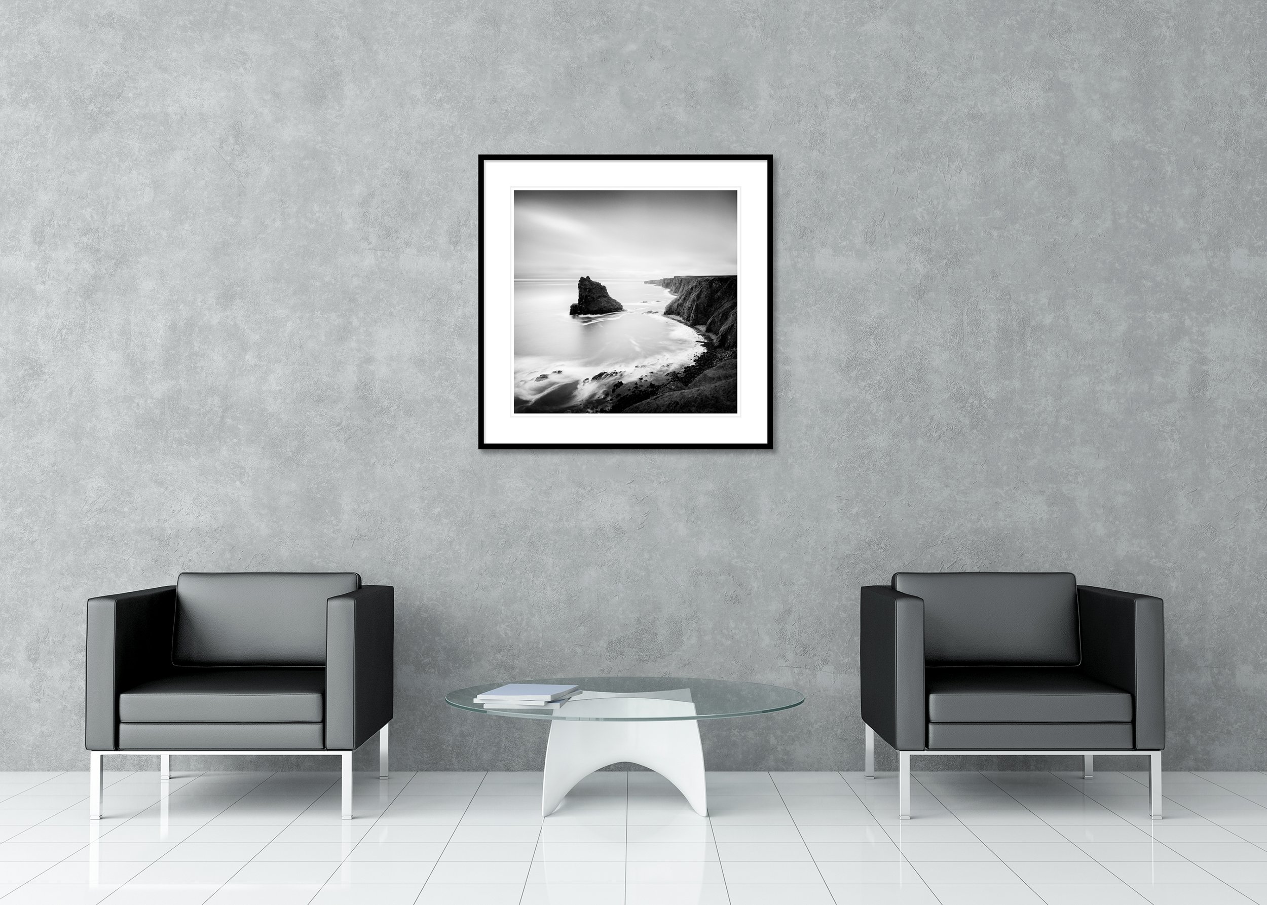 Black and white long-exposure seascape with rugged coastal cliffs and a solitary sea stack, archival pigment print in classic frame with passe-partout