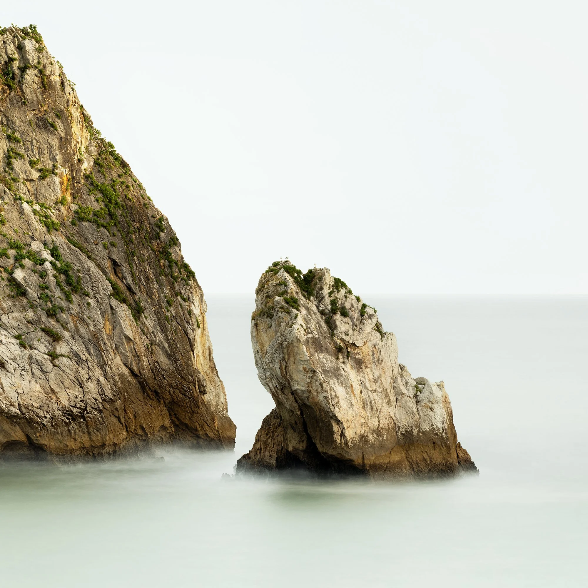 Close-up detail of the two sea stacks and softly rendered water in Two Rocks in the Sea Study 1 by Gerald Berghammer.
