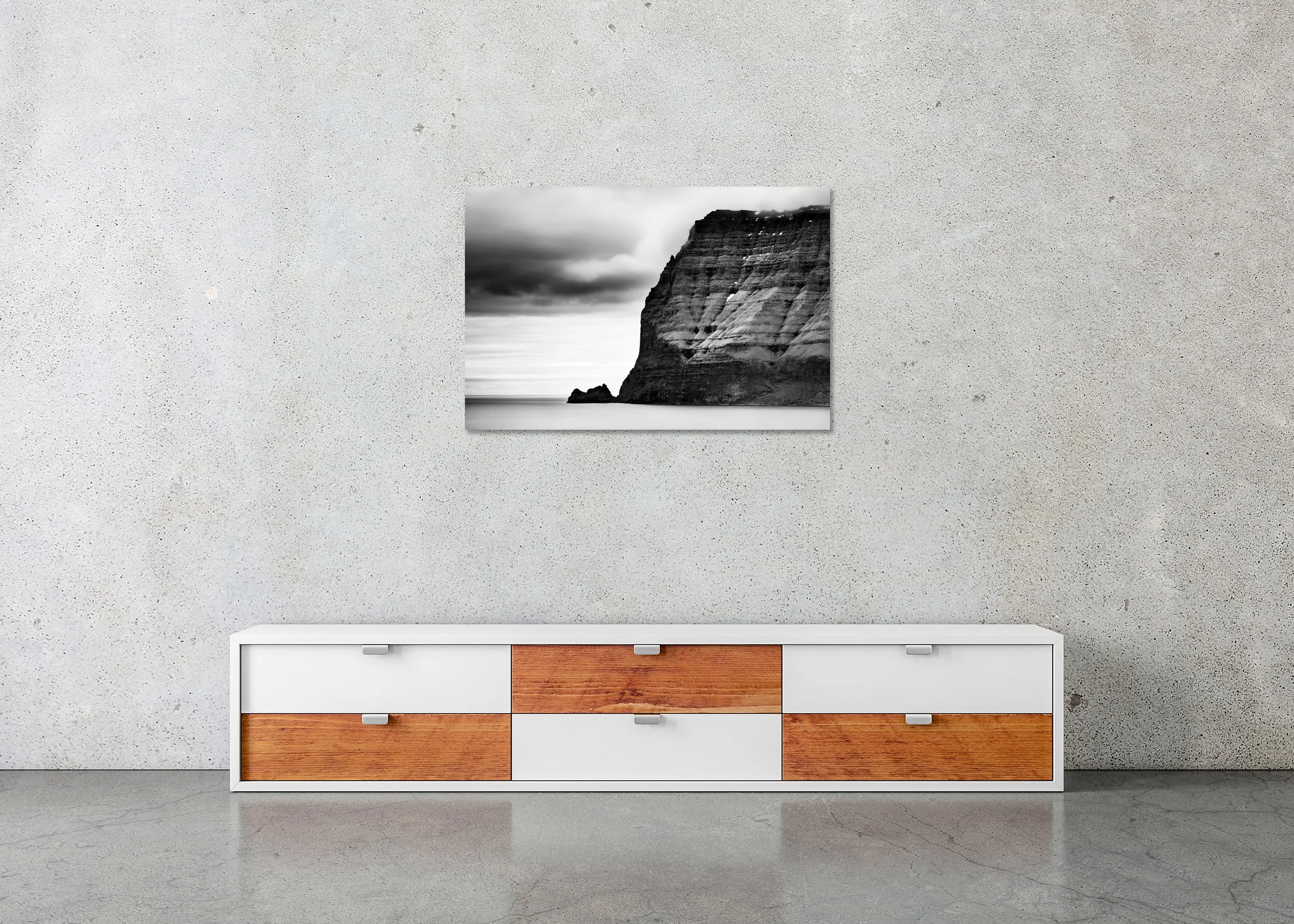 Sea Cliffs Study 2 displayed in a modern interior as a frameless black-and-white artwork mounted on aluminium Dibond. Photo by Gerald Berghammer.