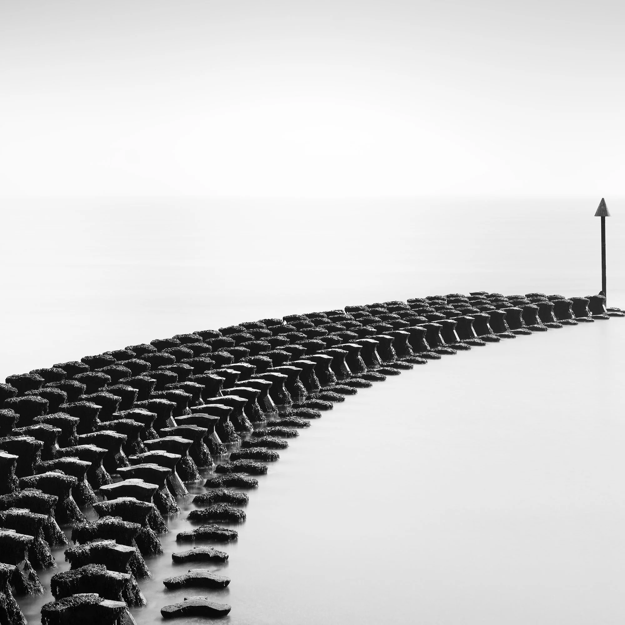 Cobbold’s Point Panorama Study 1 by Gerald Berghammer, close-up of repeating concrete breakwater blocks leading towards a navigation marker.