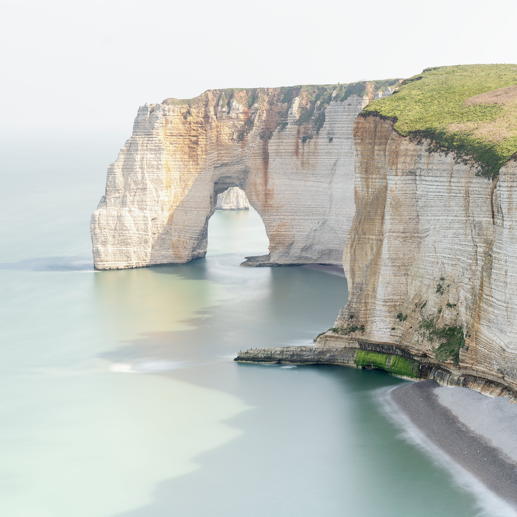 Long-exposure photograph of Étretat’s chalk cliffs and sea arch on the Alabaster Coast, France, by Gerald Berghammer.