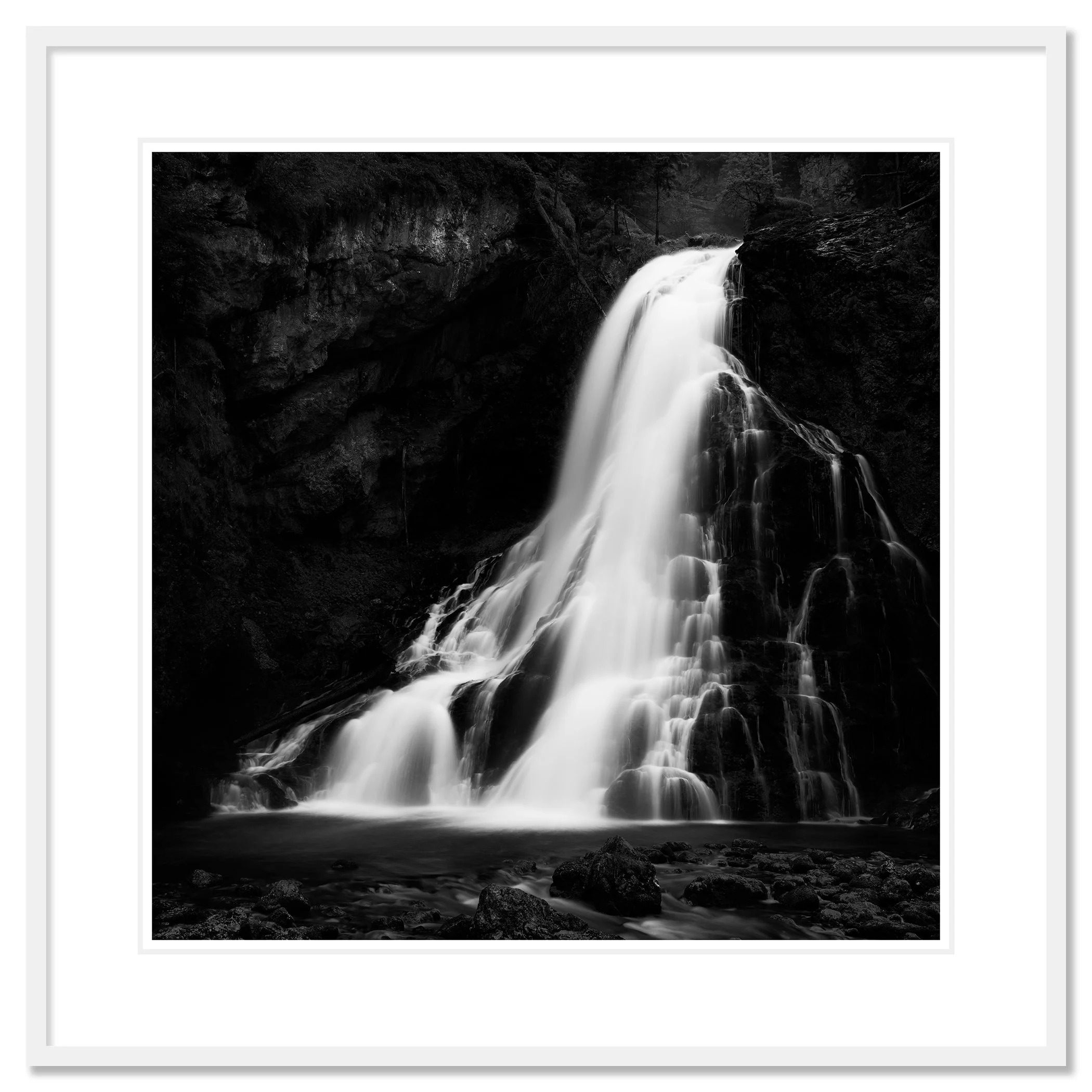 Black-and-white photograph of a waterfall cascading down a rocky cliff into a pool below, Classic frame white