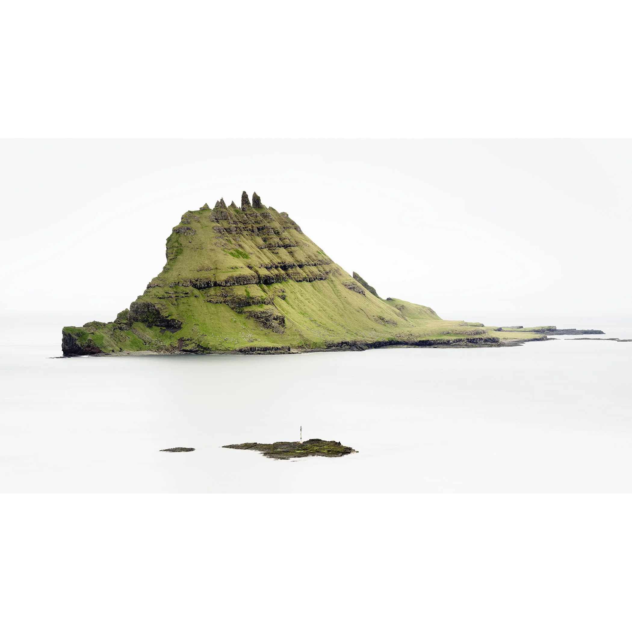 Green Rock Island – Faroe Islands, colour fine art photograph of a green volcanic island rising from a calm North Atlantic sea by Gerald Berghammer