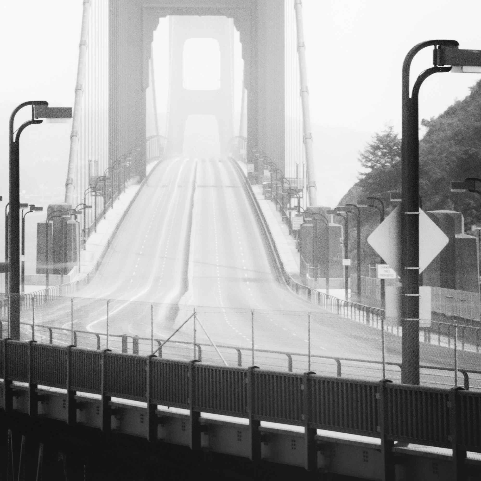 Close-up of Golden Gate Bridge Study 7 by Gerald Berghammer showing road markings, railings and streetlights fading into mist.