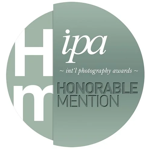 International Photography Awards 2015 Honourable Mention emblem recognising three photographic series by Gerald Berghammer and Ina Forstinger.