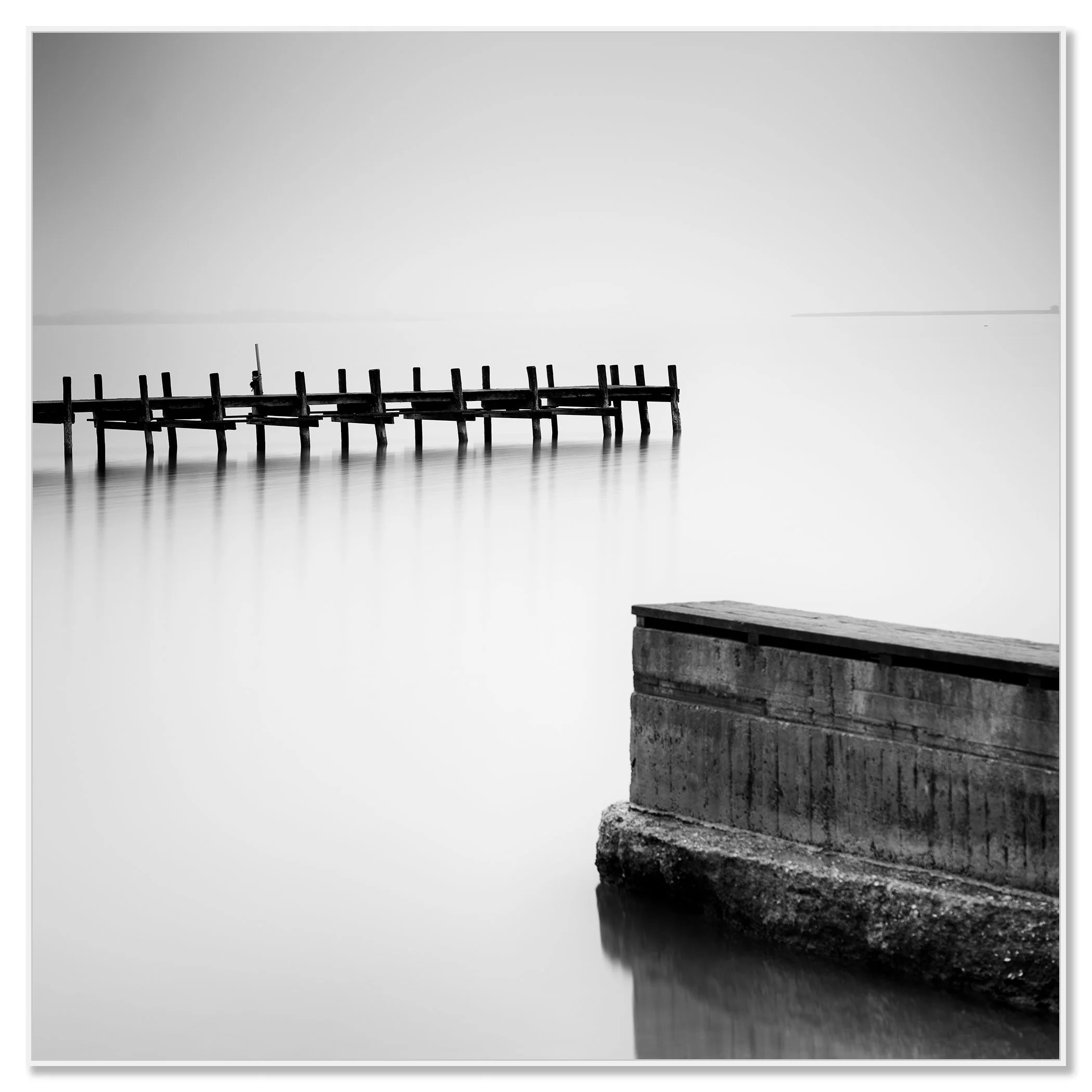 Minimalist black and white image of still water with a deserted wooden dock – framed ArtBox white