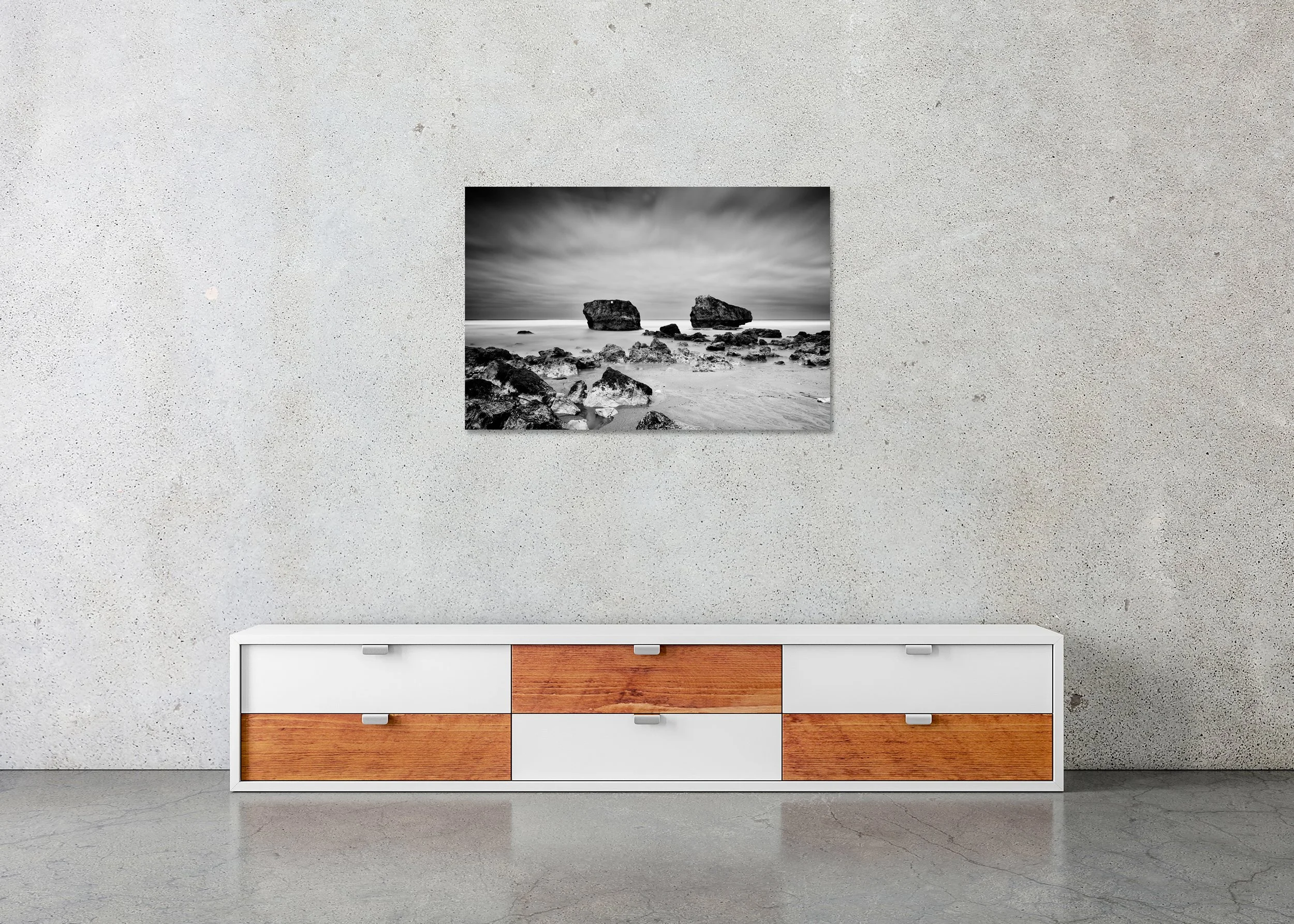 Black and white beach photograph with two rocks rising from the ocean under a cloudy sky, photo print mounted to Dibond, frameless.