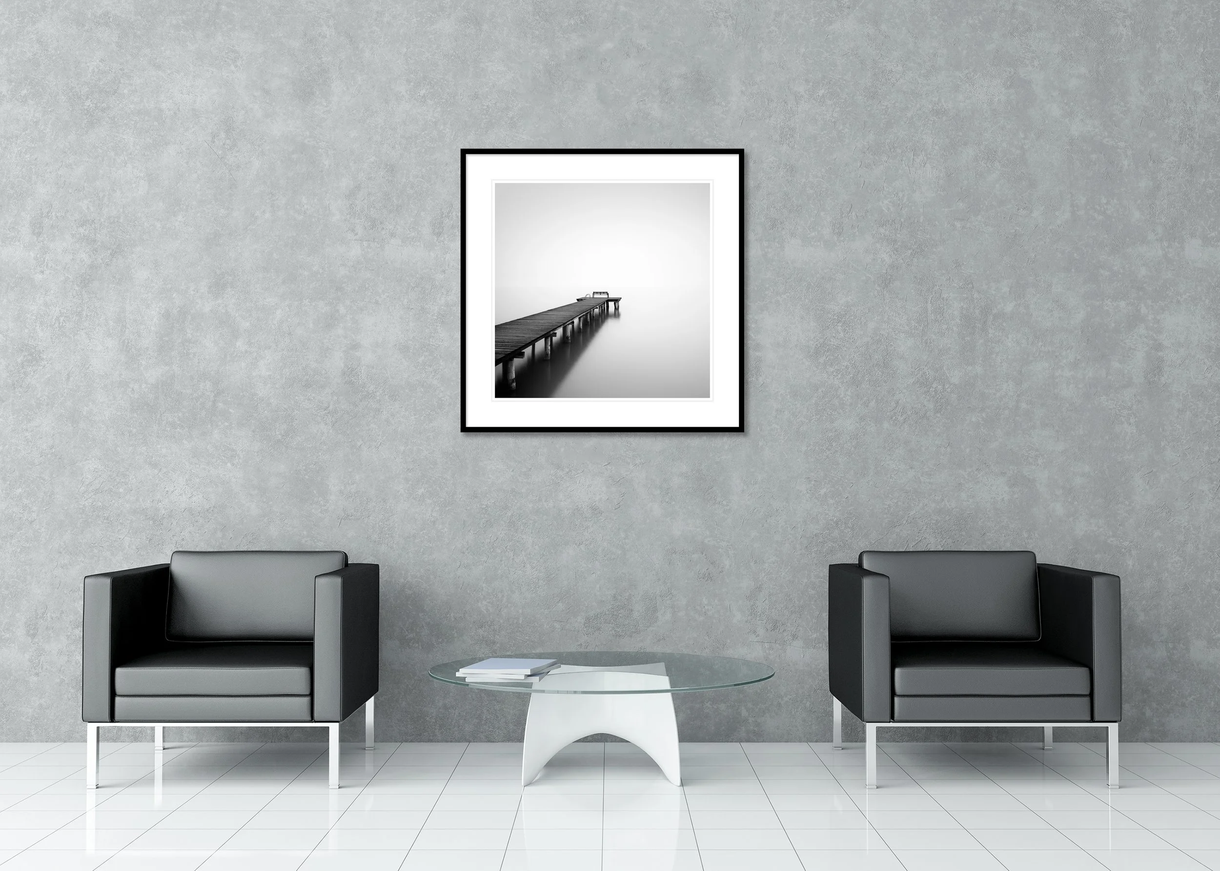 Minimalist black-and-white photo of a pier stretching into foggy, still water, with a bench at the end, presented as an archival pigment print in a classic frame with a passe-partout.