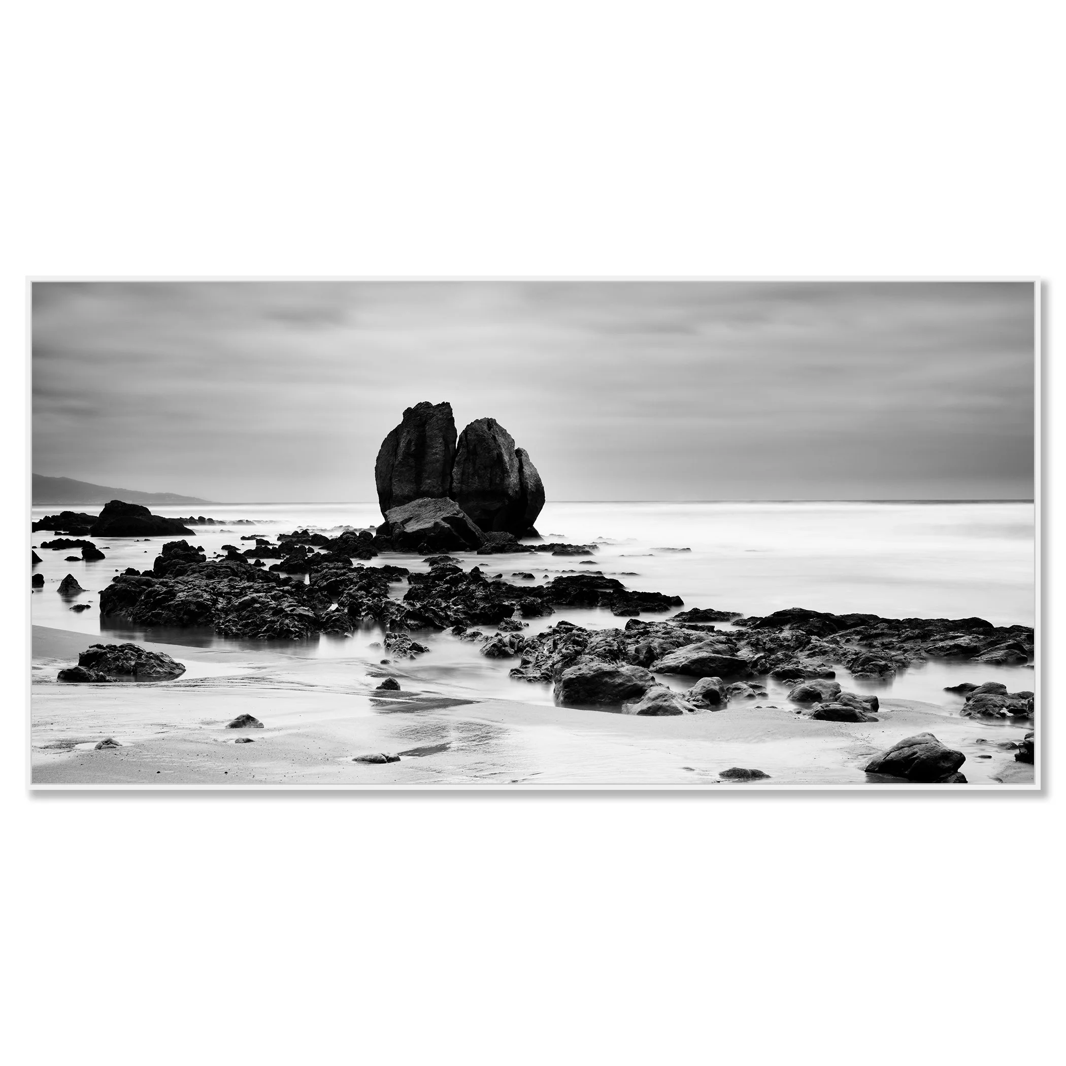Black and white coastal landscape with large sea rocks on a quiet beach – framed ArtBox white
