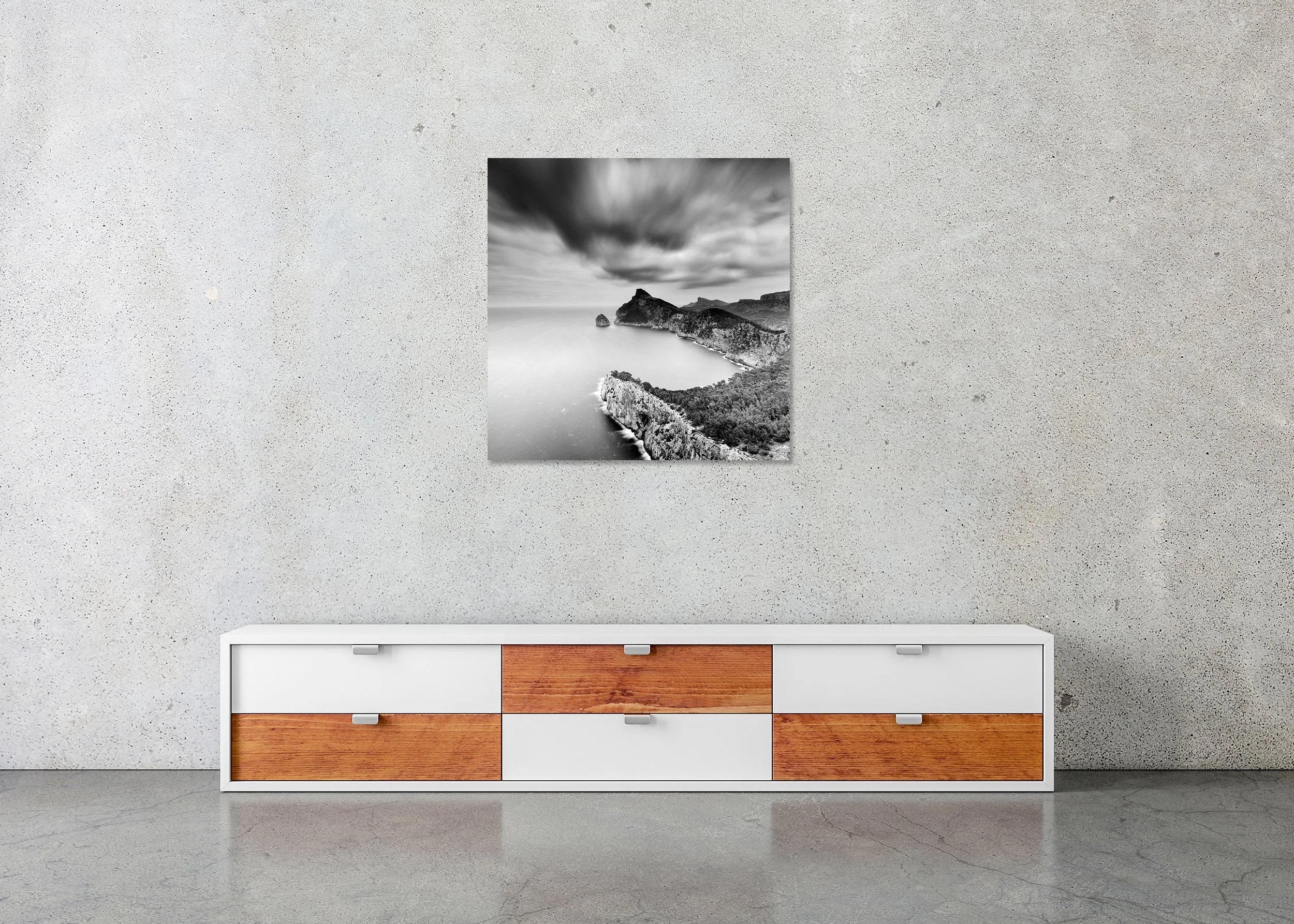 Black-and-white long-exposure coastal scene on ChromaLuxe metal print frameless, rugged sea cliffs, calm ocean water, dramatic blurred clouds.