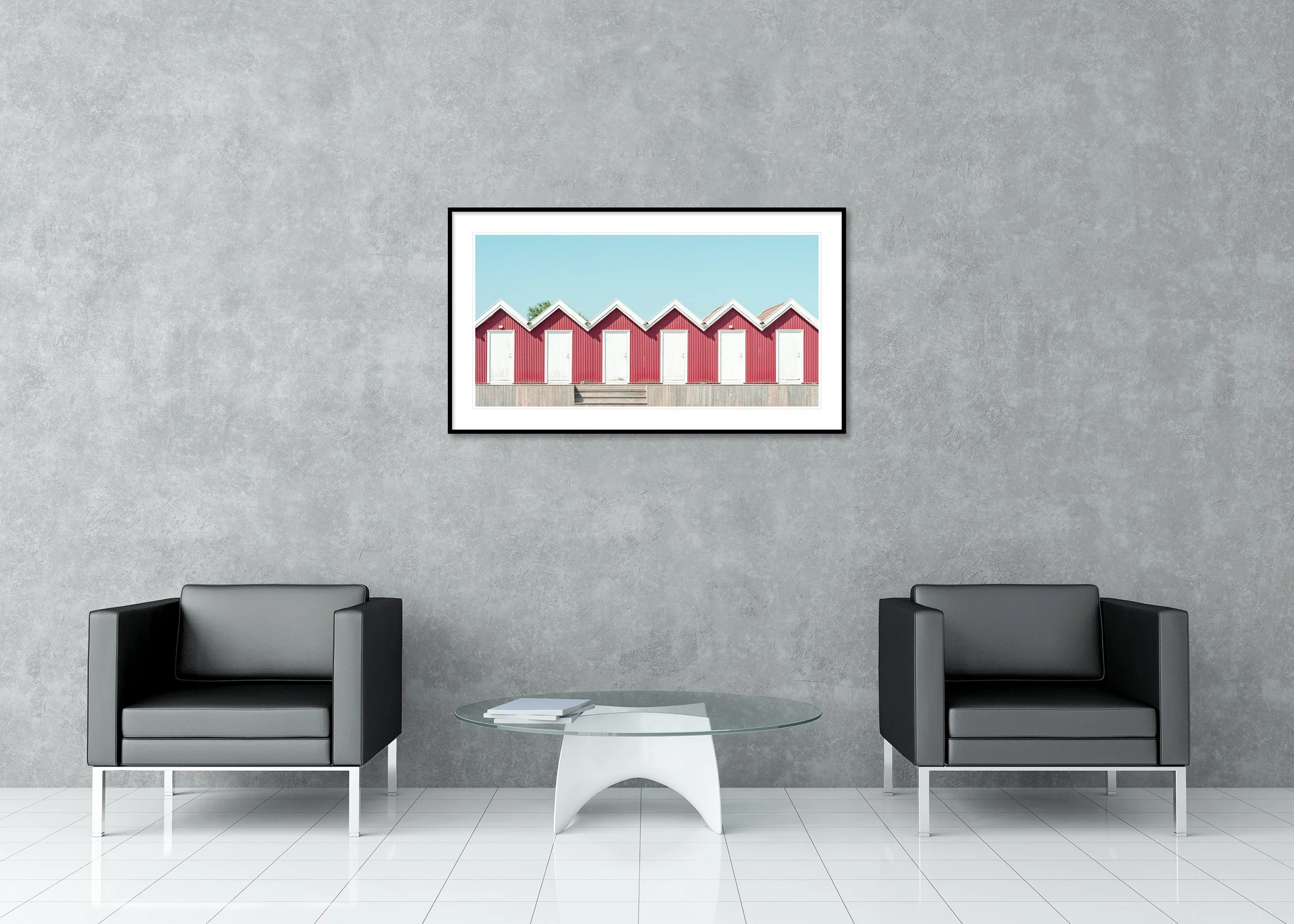 Red Beach Huts Study 1 displayed in a modern lounge as an archival pigment print in a black aluminium frame with a white mount by Gerald Berghammer.
