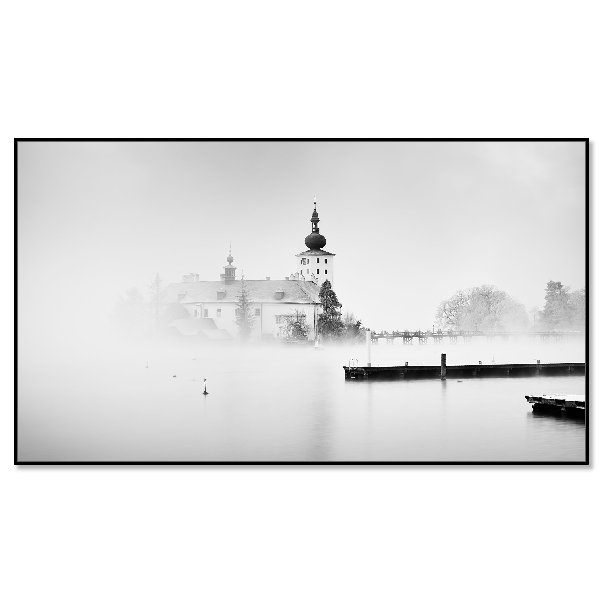 © 2022 Gerald Berghammer - Black and white cityscape photography. Schloss Ort - The historic church surrounded by mist over a lake with docks in the foreground. Chromaluxe framed black