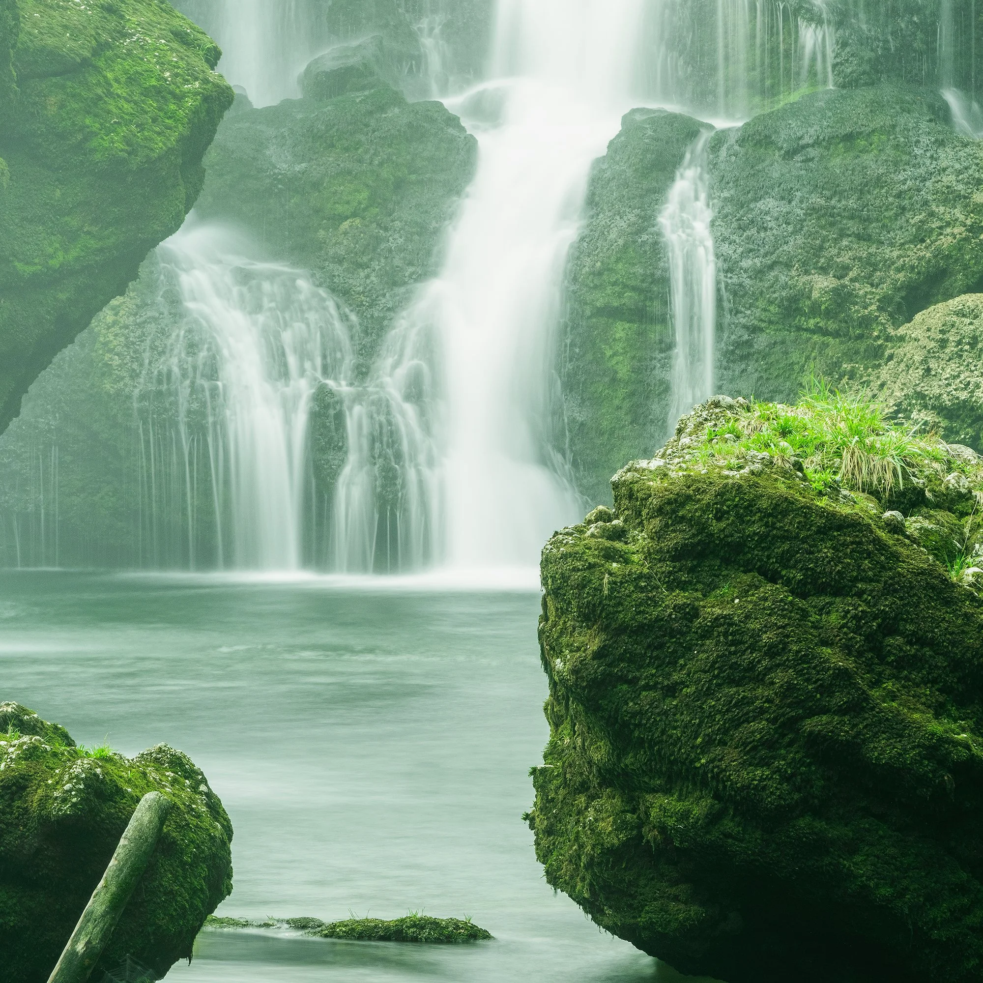 Detail of Moss-Covered Waterfall Study 1 showing cascading water, a moss-covered rock and the tranquil pool by Gerald Berghammer.