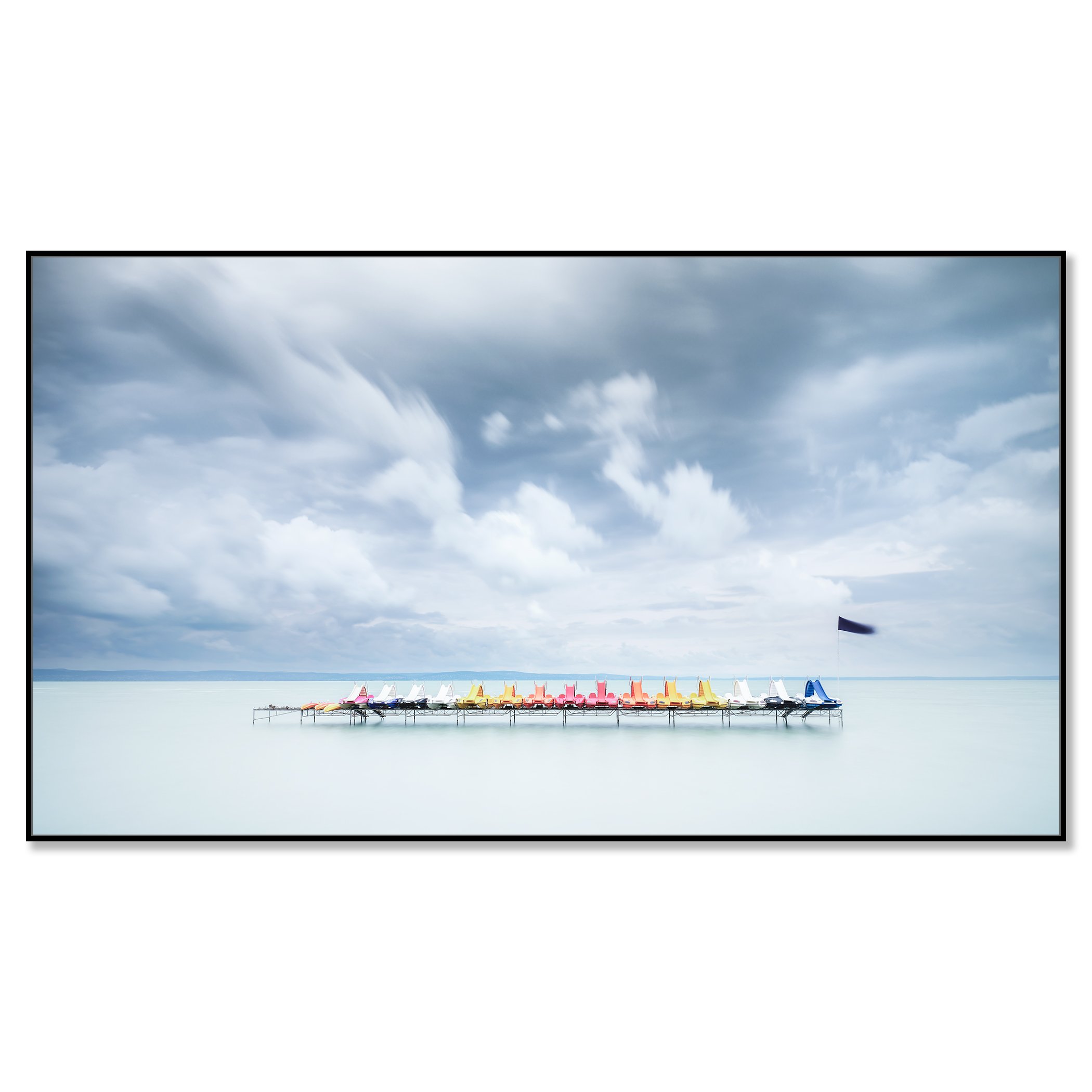 Gerald Berghammer - Color long exposure waterscape photography. Colorful paddle boats lined up on a dock over calm water, under a cloudy sky. Chromaluxe framed black
