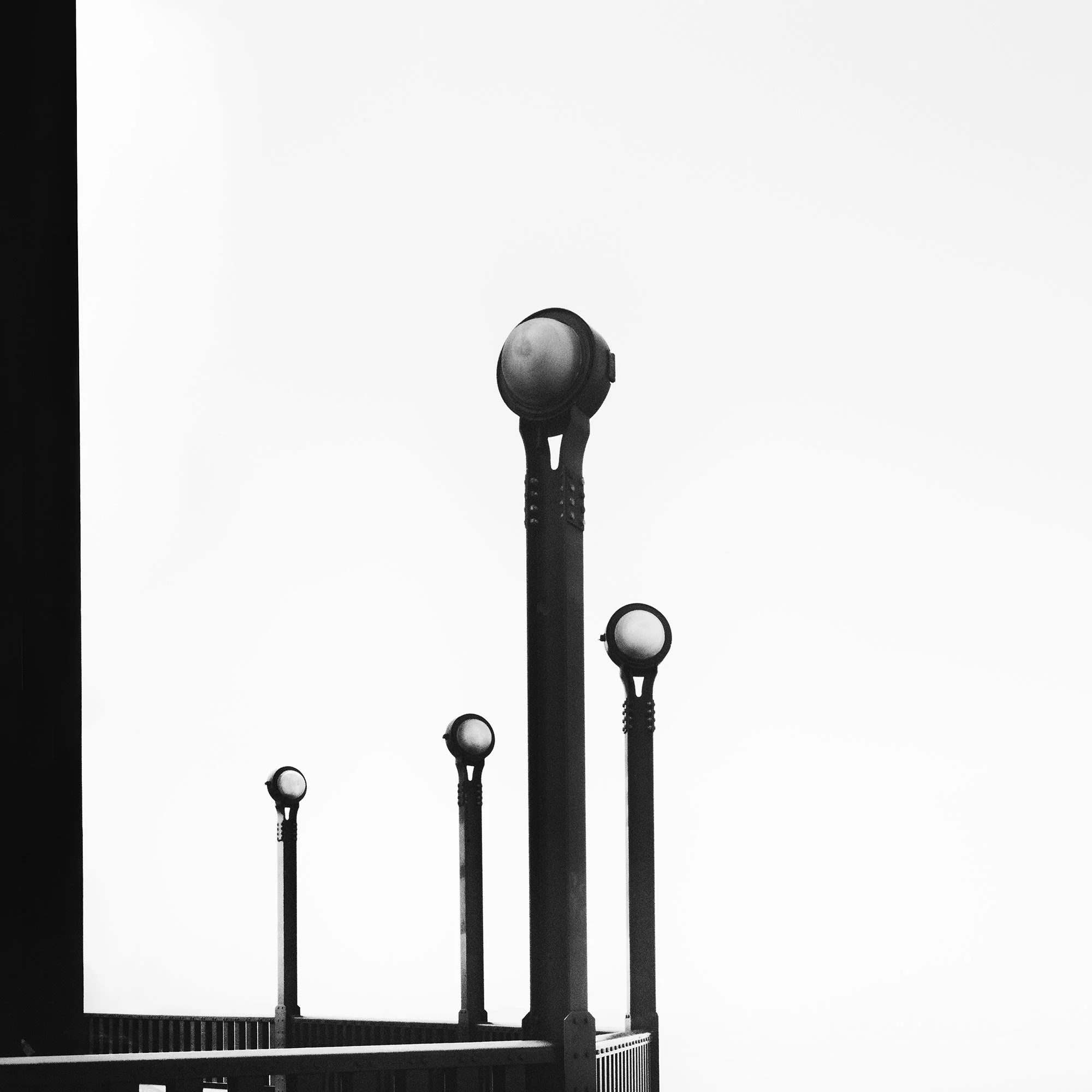 Golden Gate, Study 6 – detail of the Golden Gate Bridge lamps and railings against an expansive white sky by Gerald Berghammer.