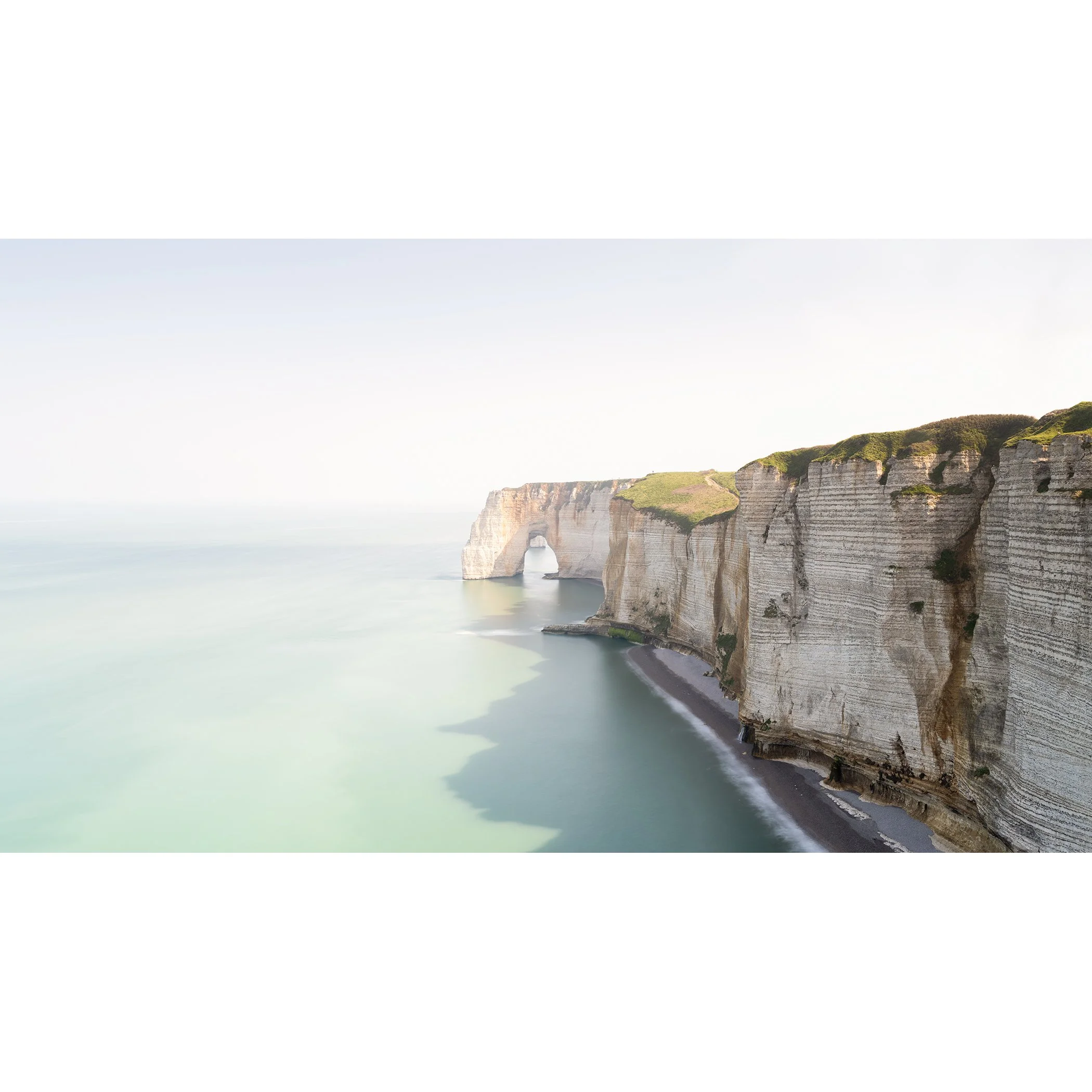 White Cliffs Panorama Study 2 by Gerald Berghammer, colour long-exposure photograph of the chalk cliffs and natural sea arch at Étretat, France.