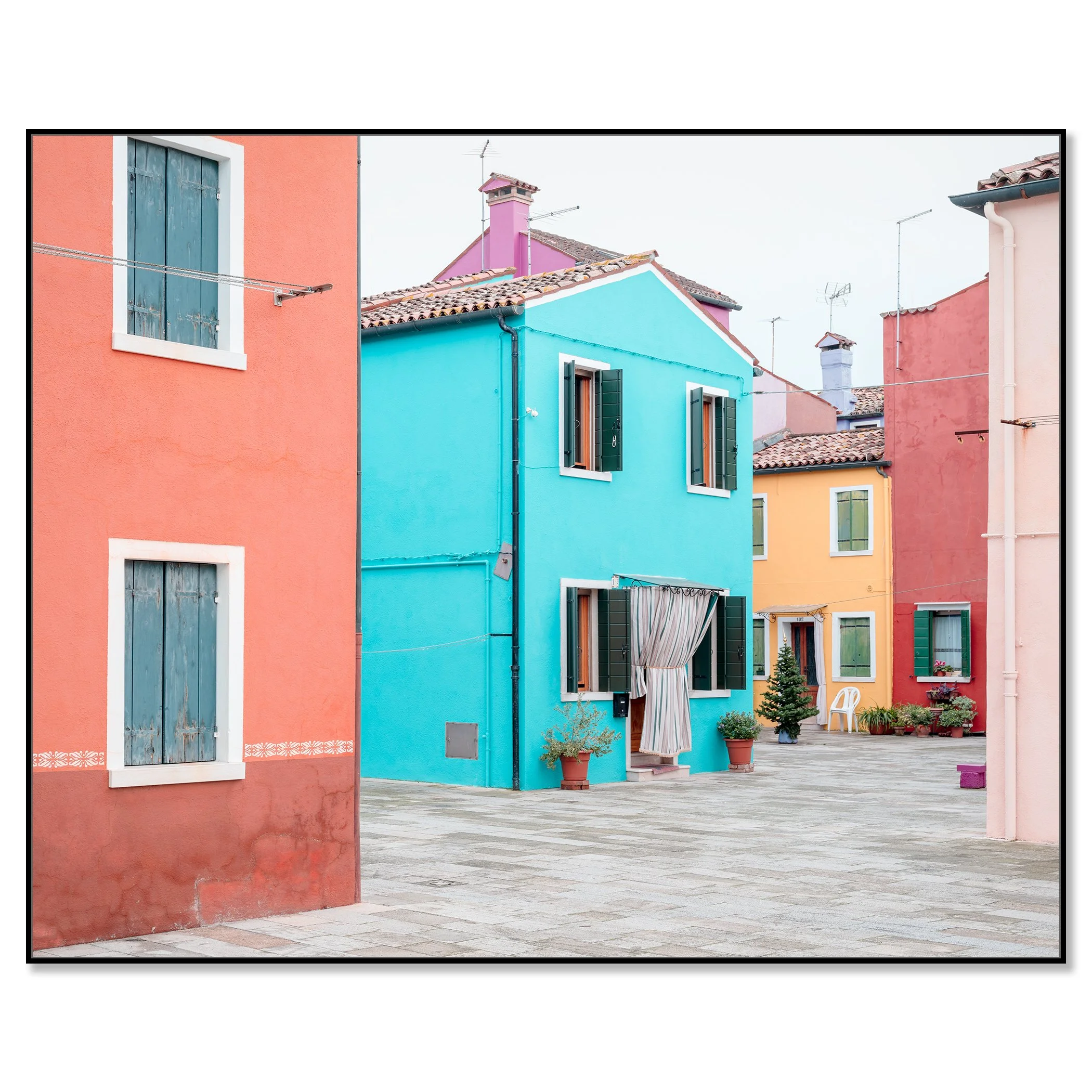 © 2025 Gerald Berghammer - Color cityscape photography. Colorful buildings with pastel pink, blue, yellow, and red walls, windows, and open shutters in a courtyard. Chromaluxe framed black