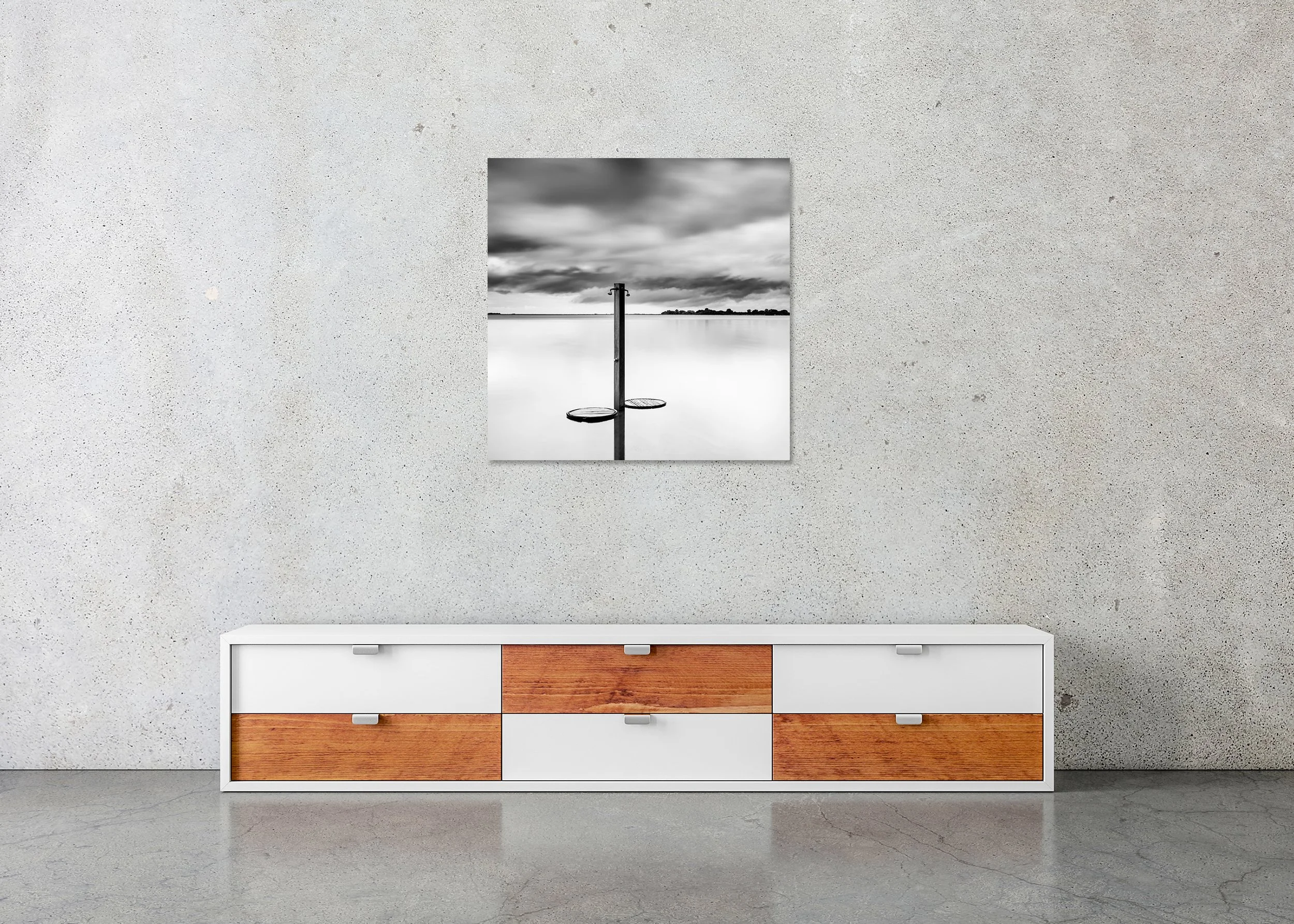 Beach Shower in a Storm displayed in a modern interior as a frameless black-and-white aluminium Dibond print by Gerald Berghammer.