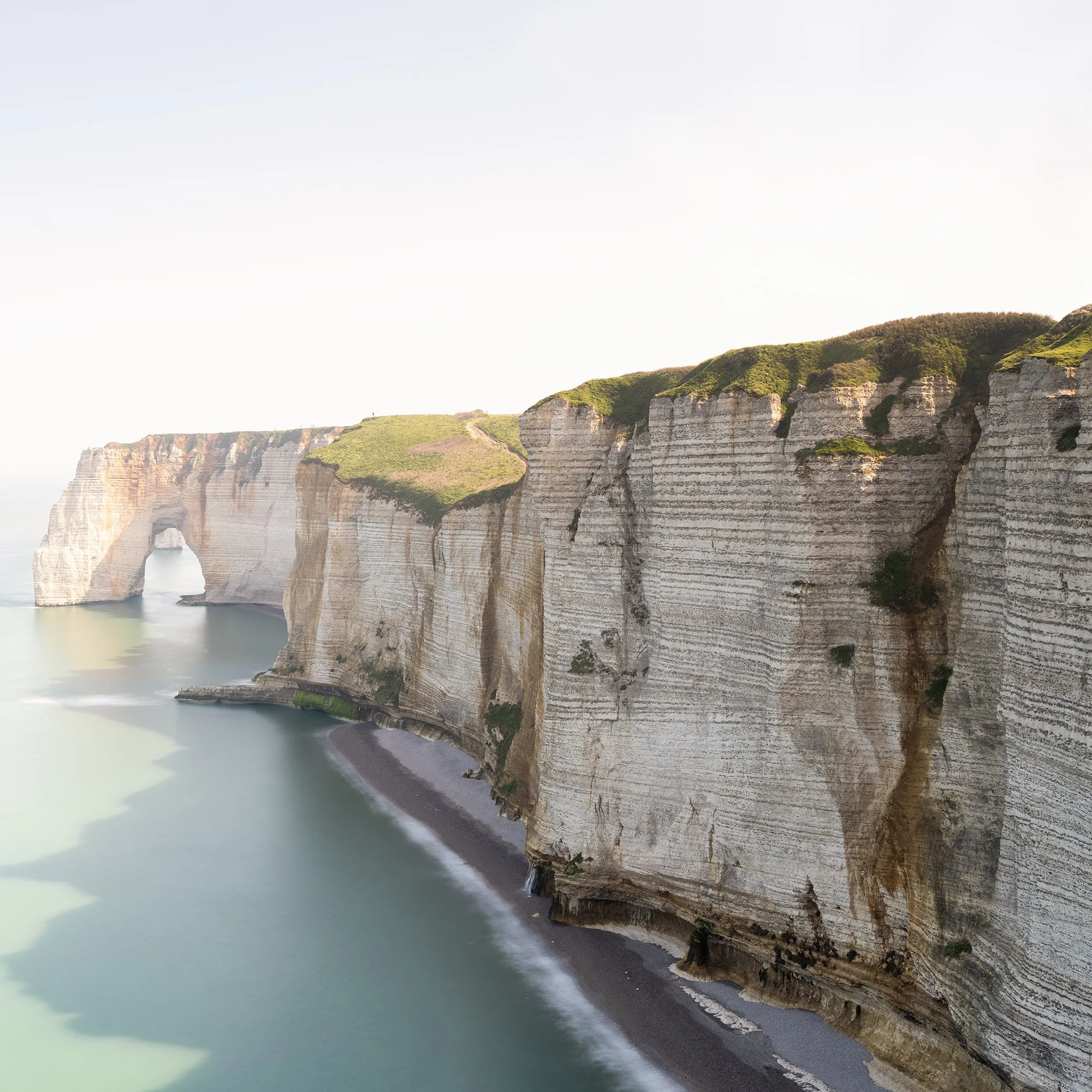 Detail of White Cliffs Panorama Study 2 by Gerald Berghammer showing the layered chalk cliffs and shoreline at Étretat, France.