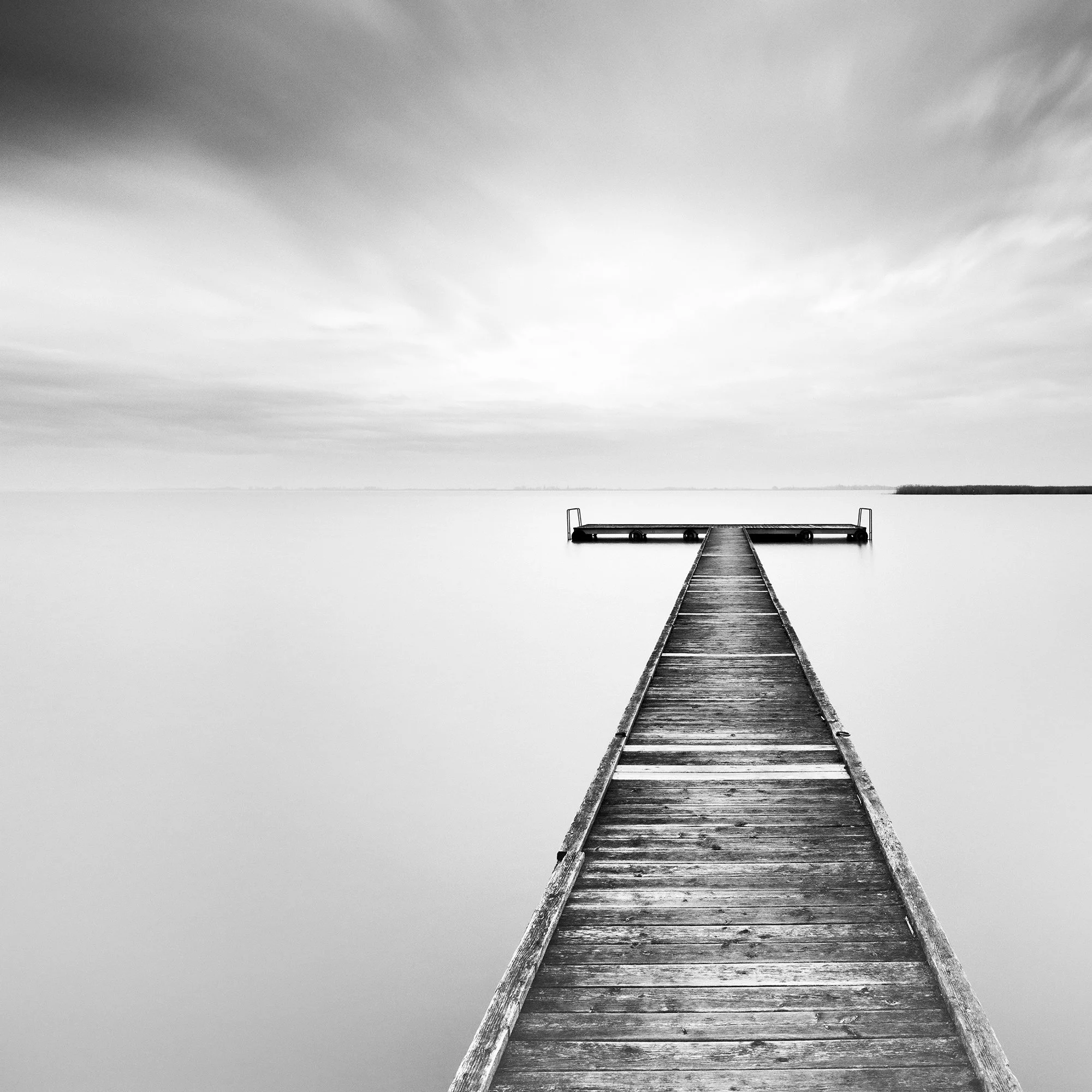 Close-up of Winter Storm showing the wooden jetty and long-exposure waterscape of Lake Neusiedl by Gerald Berghammer.