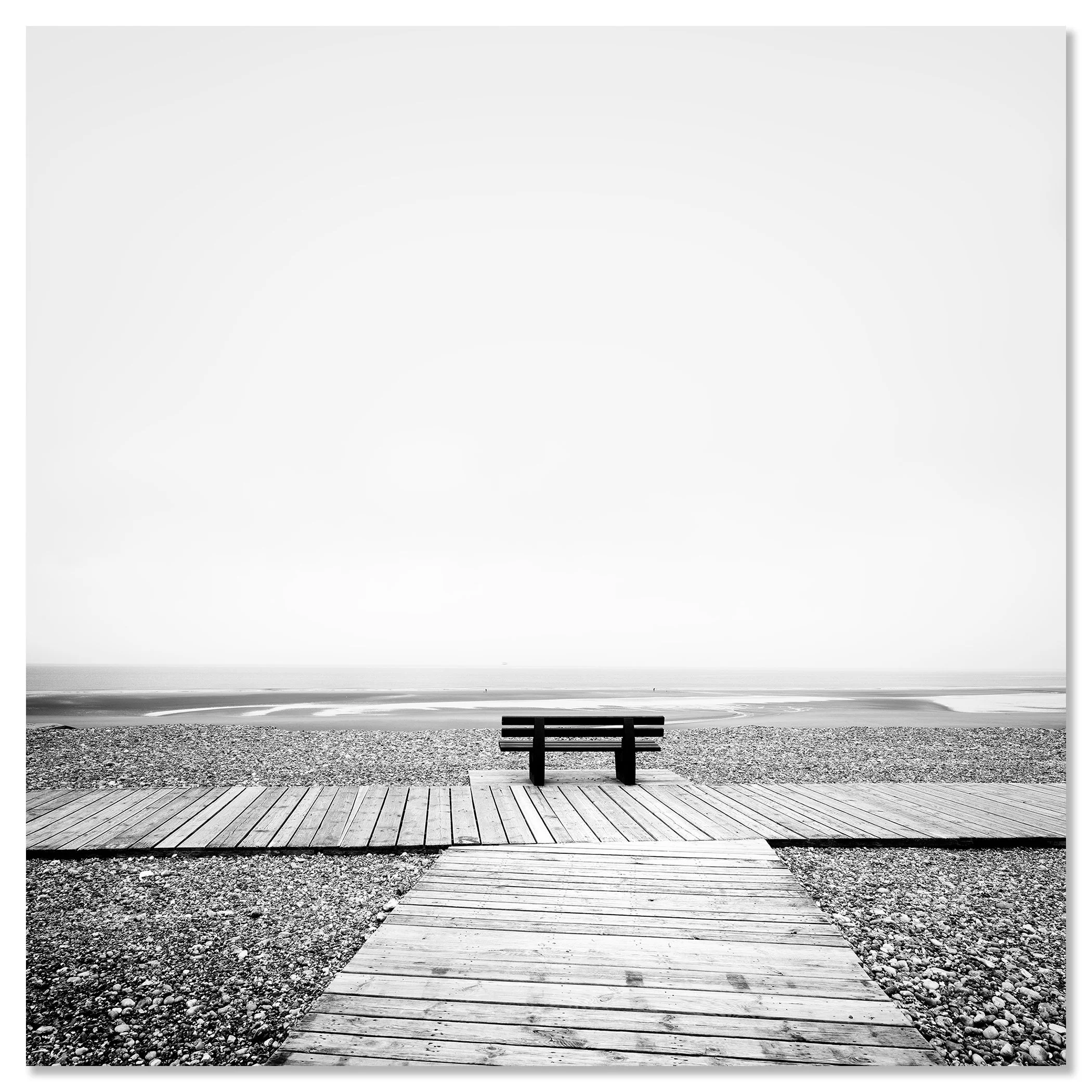 Wooden boardwalk and bench overlooking the Atlantic Ocean in black and white, with calm water and rocky shore – dibond frameless