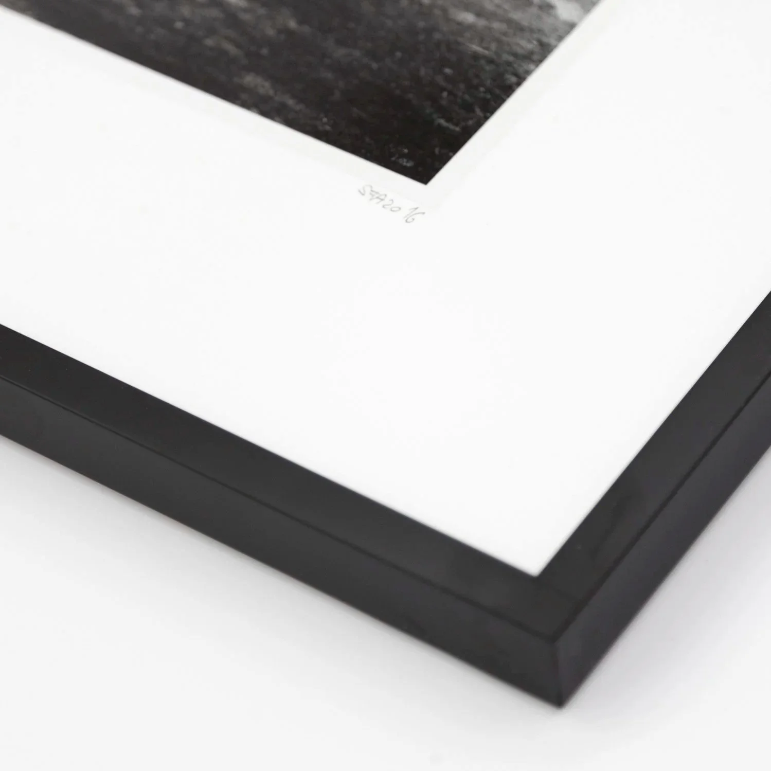 Detail of Into the Wild by Gerald Berghammer, showing the black wooden frame, natural-white archival mount and handwritten print number.