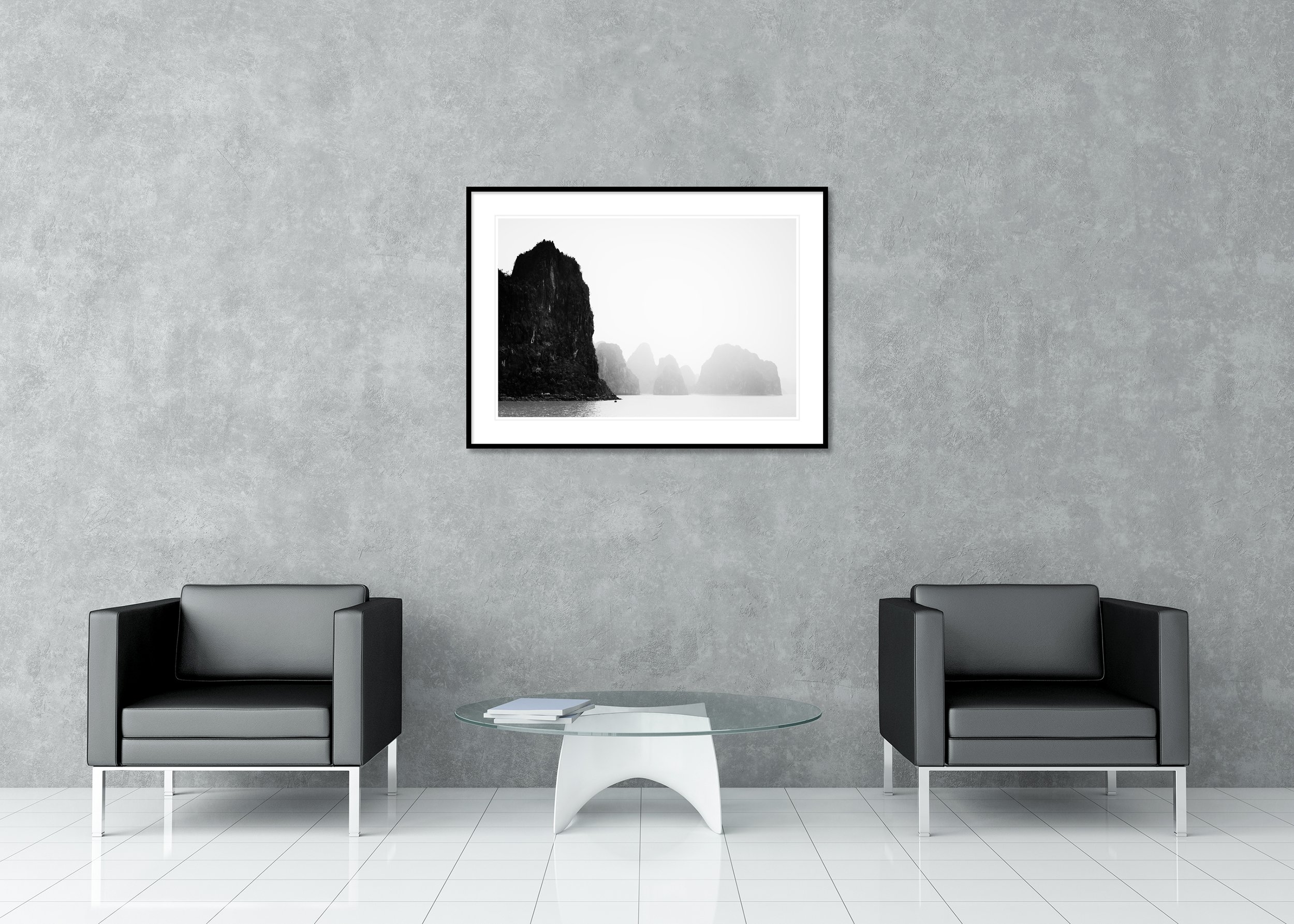 Karst limestone islands rising from the sea with a misty background and muted overcast sky, archival pigment print in a classic frame with a mount.