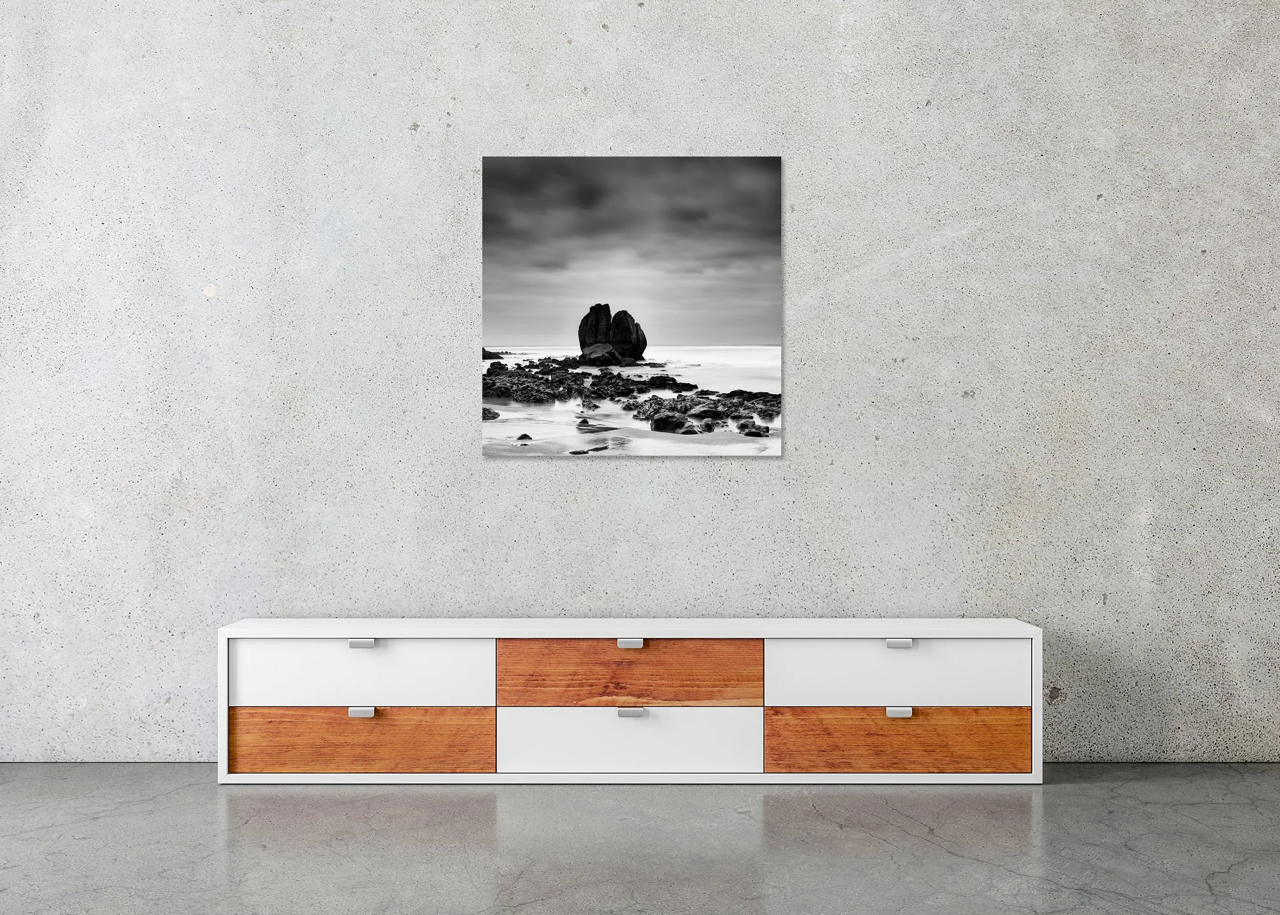 Rocks on the Shore Study 2 displayed in a modern interior as a frameless black-and-white artwork mounted on aluminium Dibond by Gerald Berghammer.
