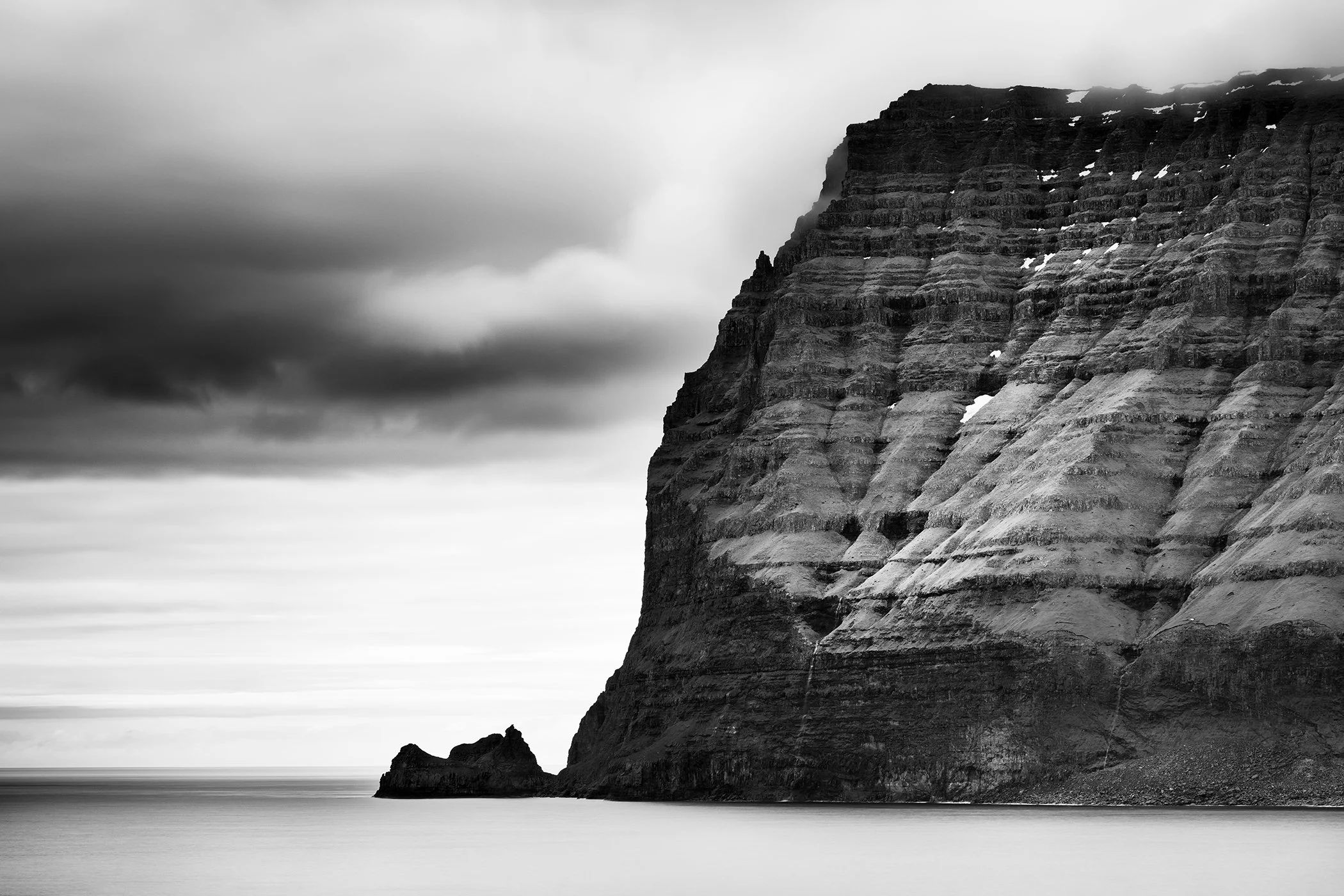 Sea Cliffs Study 2, black-and-white fine art photograph of a monumental sea cliff rising from the North Atlantic Ocean in the Faroe Islands by Gerald Berghammer.
