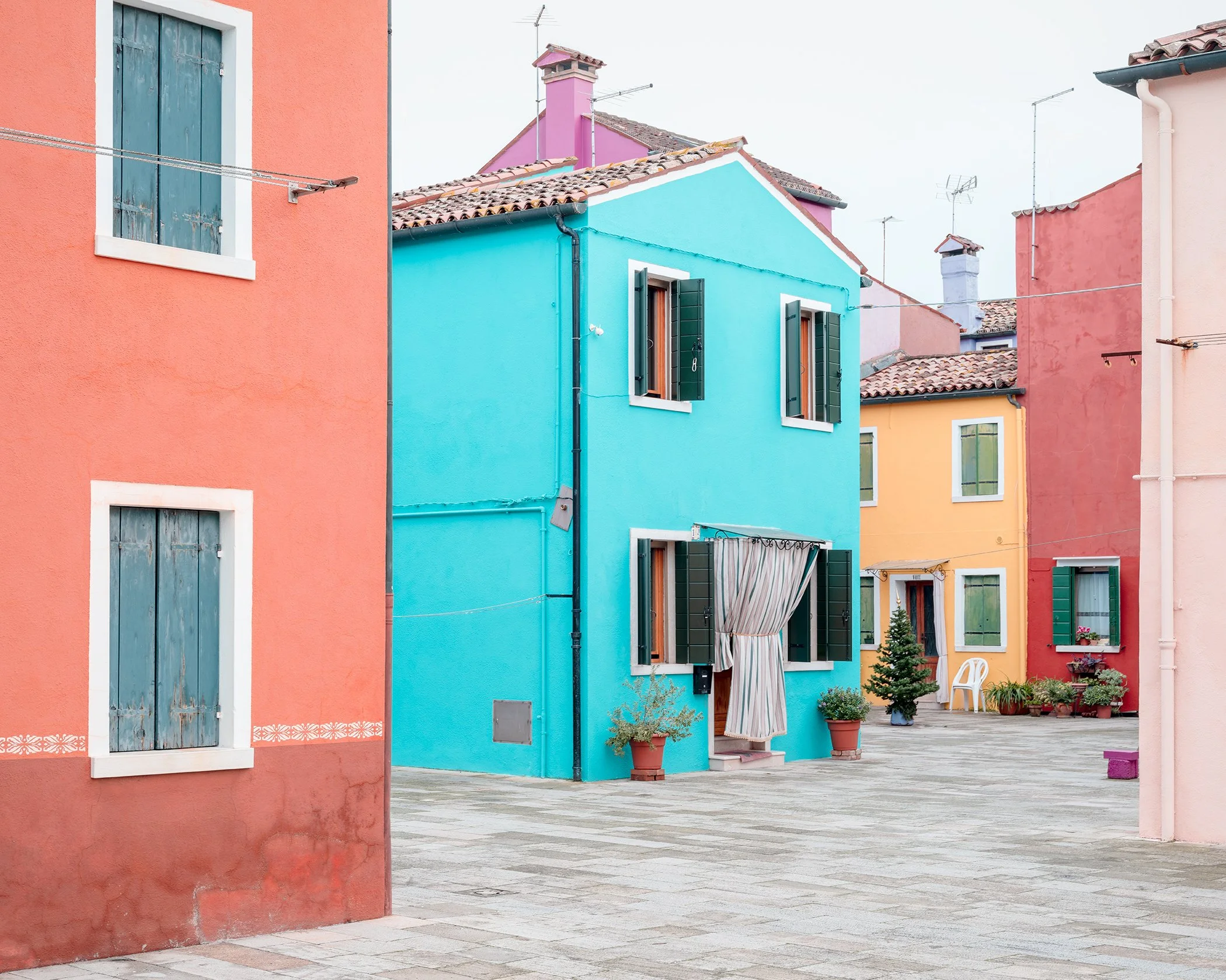 The Turquoise House, colourful architecture surrounding a quiet paved lane in Burano, Venetian Lagoon, Venice, by Gerald Berghammer.