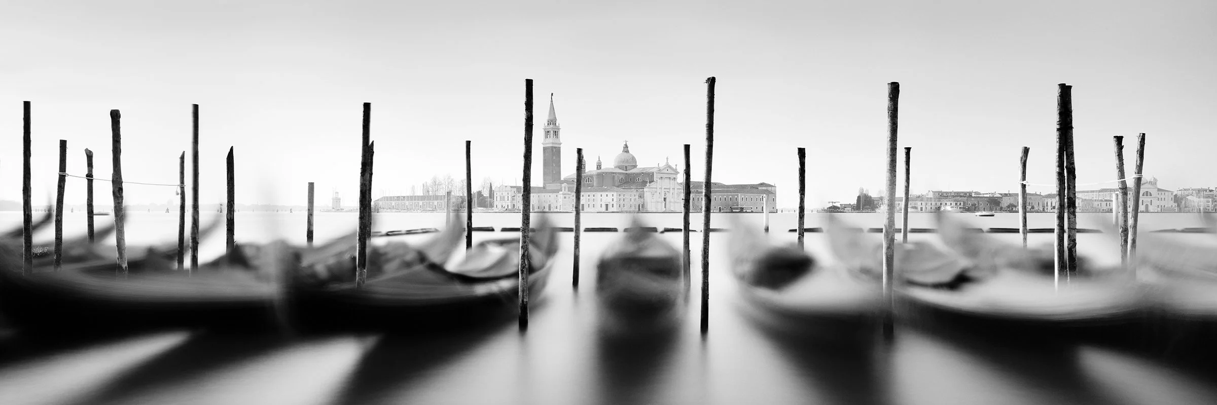 Basilica and Gondola Study 1 by Gerald Berghammer, black-and-white long-exposure panorama of gondolas in Venice, Italy.