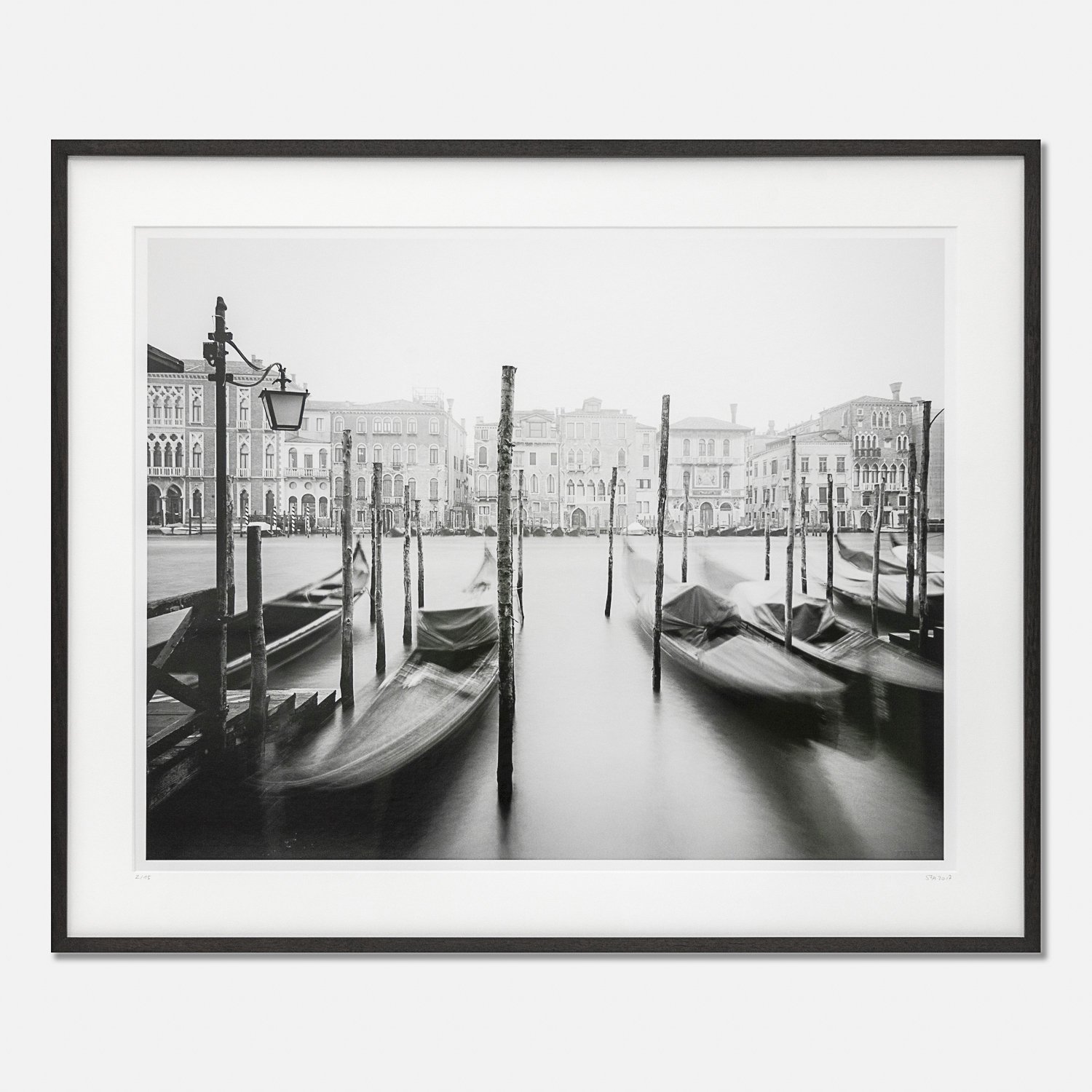 Framed Gondola Study 1 by Gerald Berghammer, black-and-white photograph of Venetian gondolas, wooden mooring posts and historic palazzi.