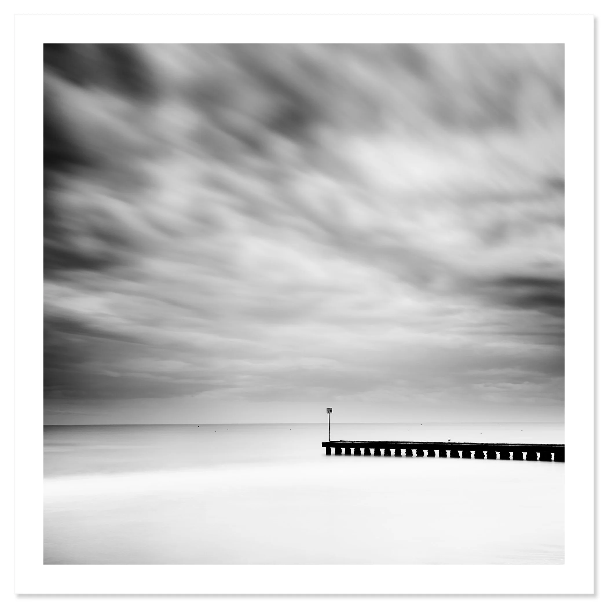 Wooden Pier in the Sea Study 1 – black-and-white long-exposure seascape from Italy as an archival fine art print by Gerald Berghammer.