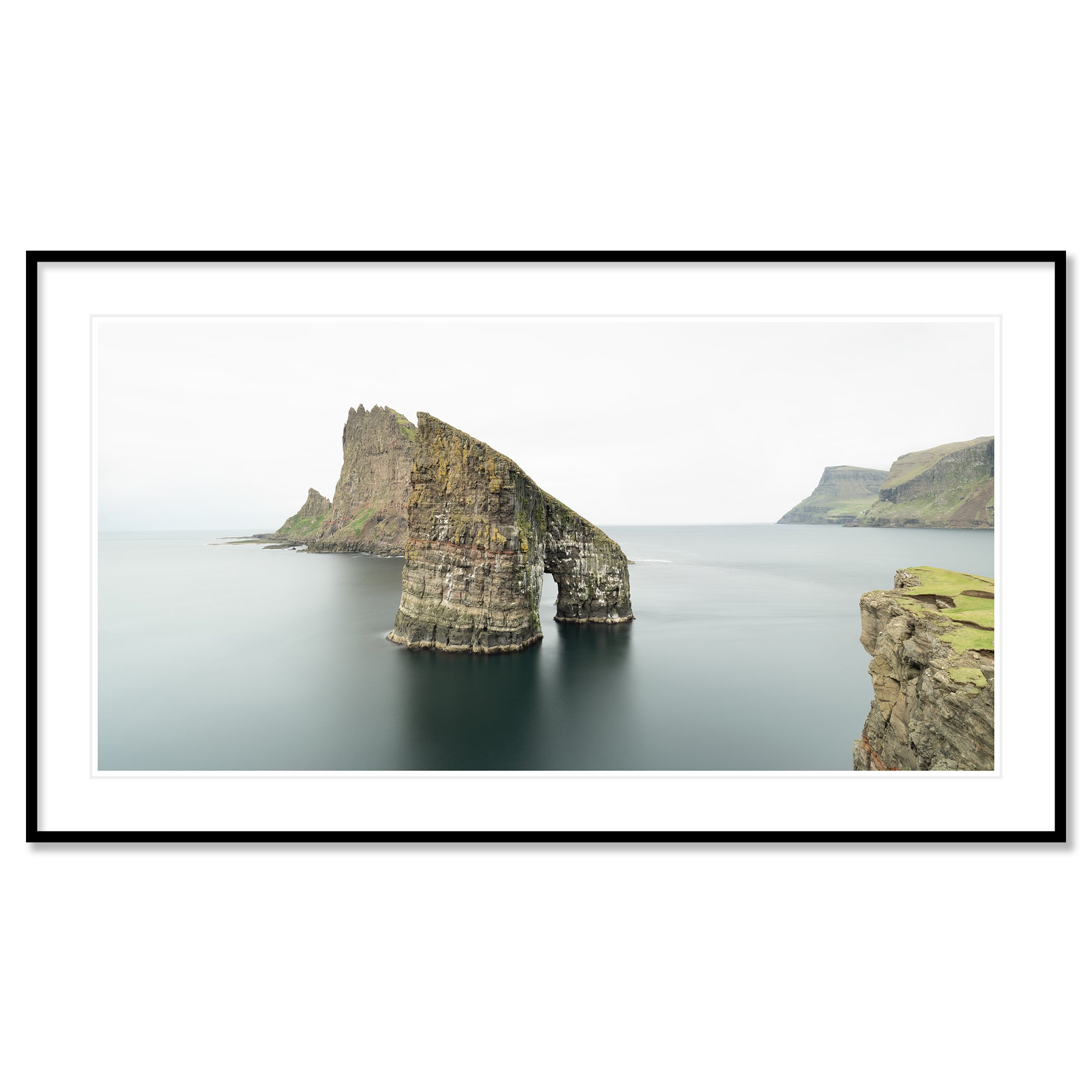 Gerald Berghammer - Color seascape panorama photography. Cliffs and sea stacks along a coastline under an overcast sky. Classic framed black