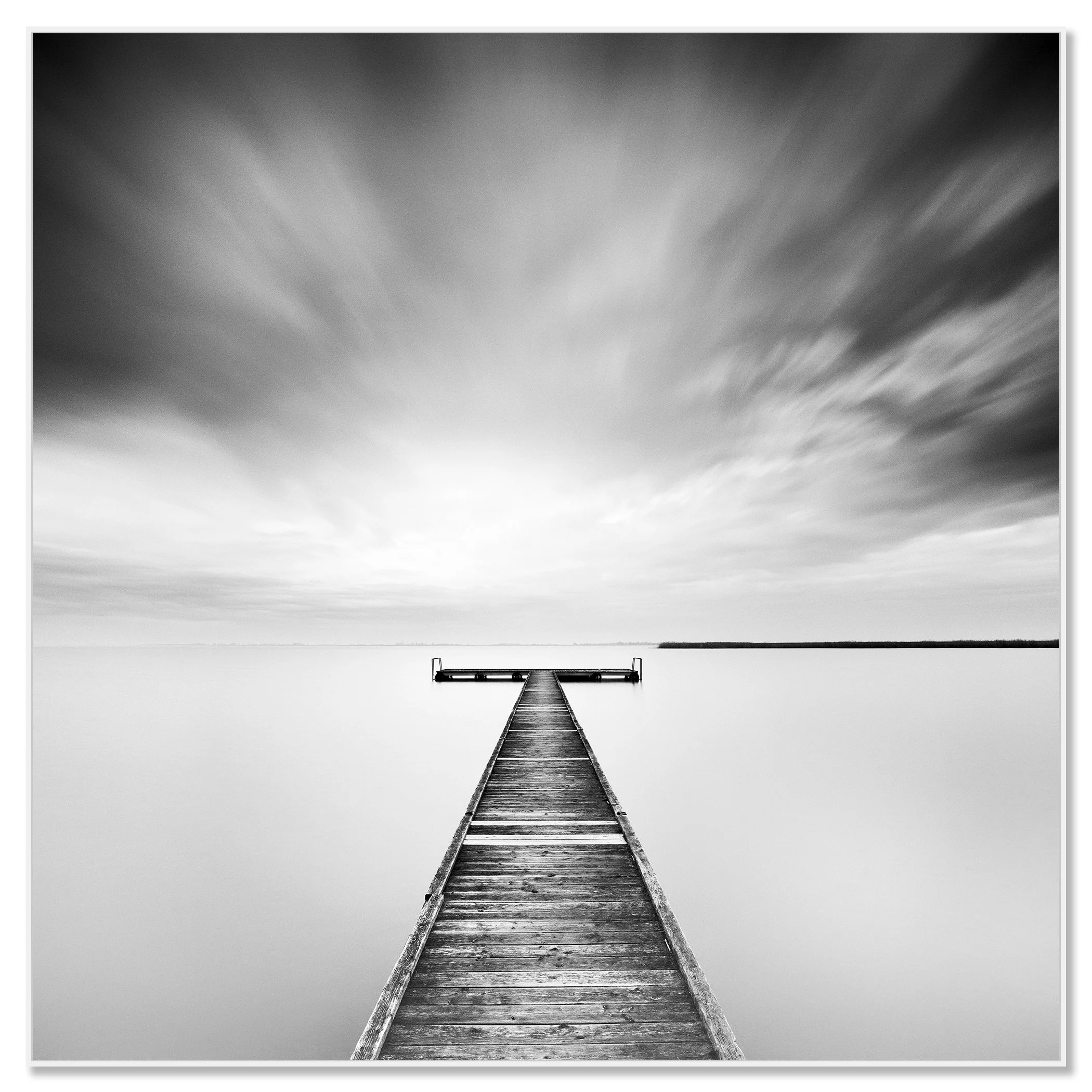 Minimalist black and white landscape photograph of a quiet pier extending into peaceful water – framed ArtBox white