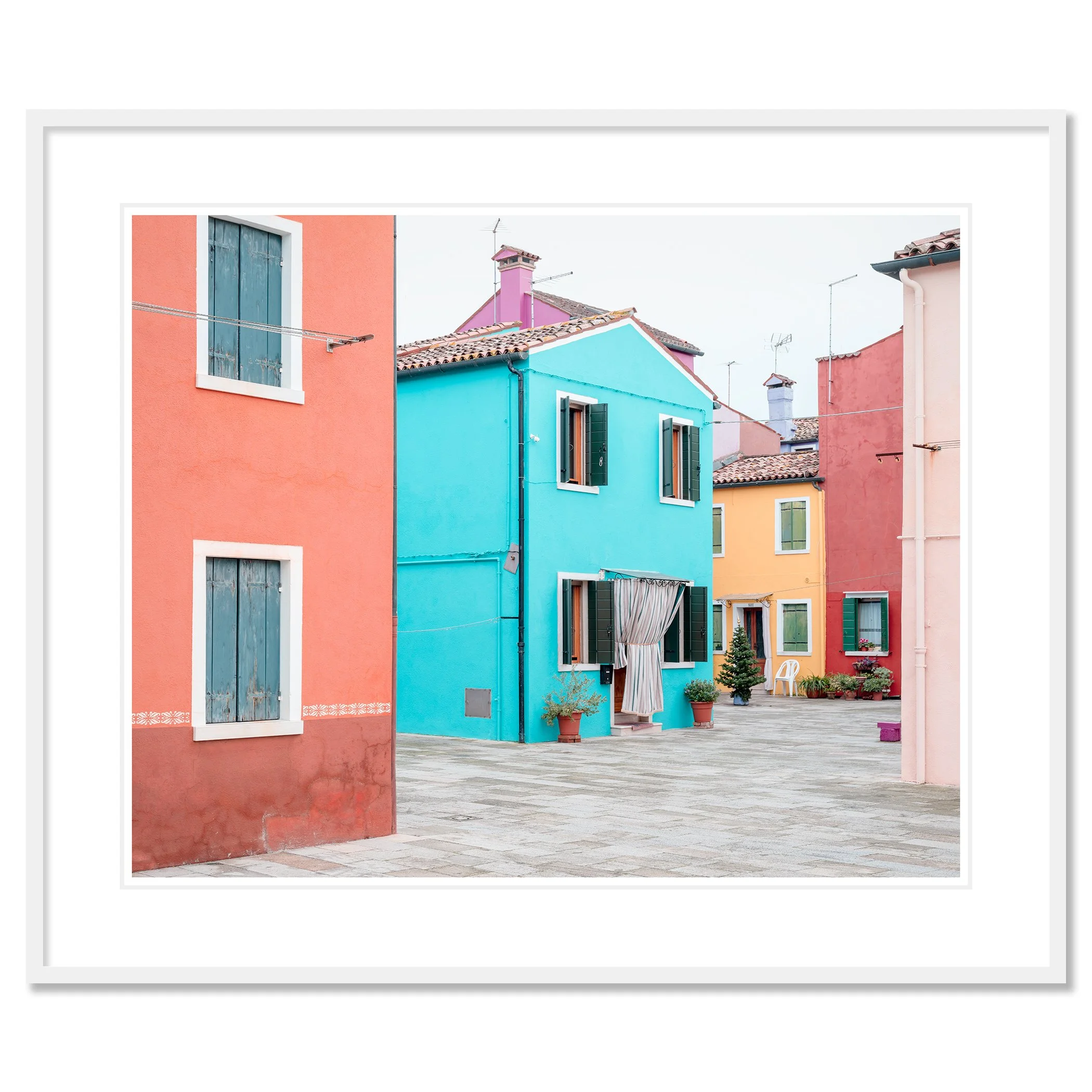 © 2025 Gerald Berghammer - Color cityscape photography. Colorful buildings with pastel pink, blue, yellow, and red walls, windows, and open shutters in a courtyard. Classic framed white