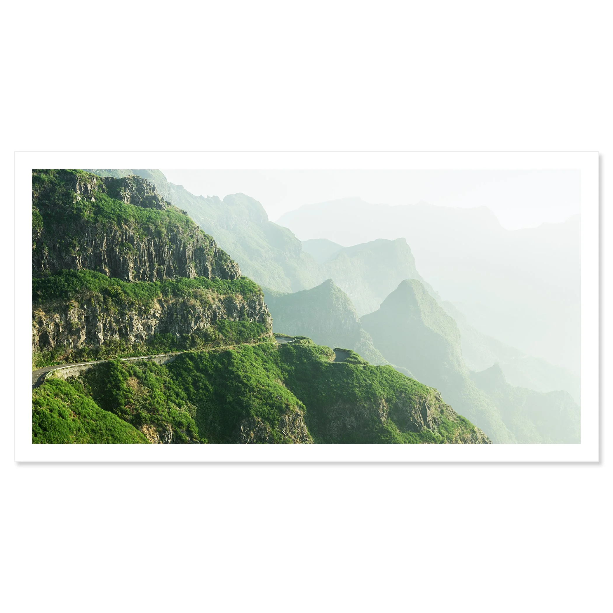 © 2021 Gerald Berghammer - Color Fine Art Landscape Photography. A winding mountain road through lush green cliffs and misty mountains in the background. Fine art print only
