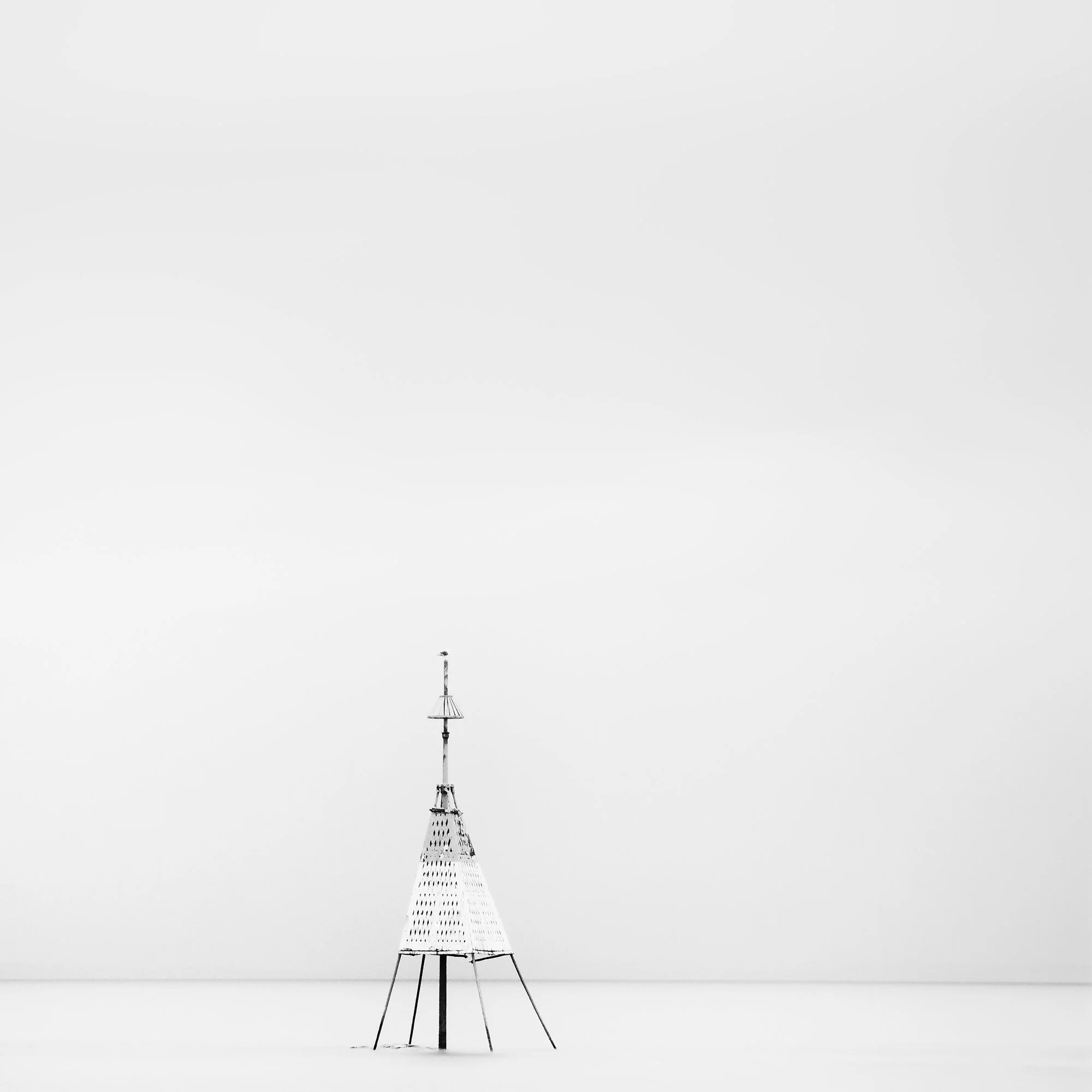 Gerald Berghammer - Black and white long exposure seascape photography. Solitary metal structure lighthouse with a conical top, standing in the Ocean. Print detail 2