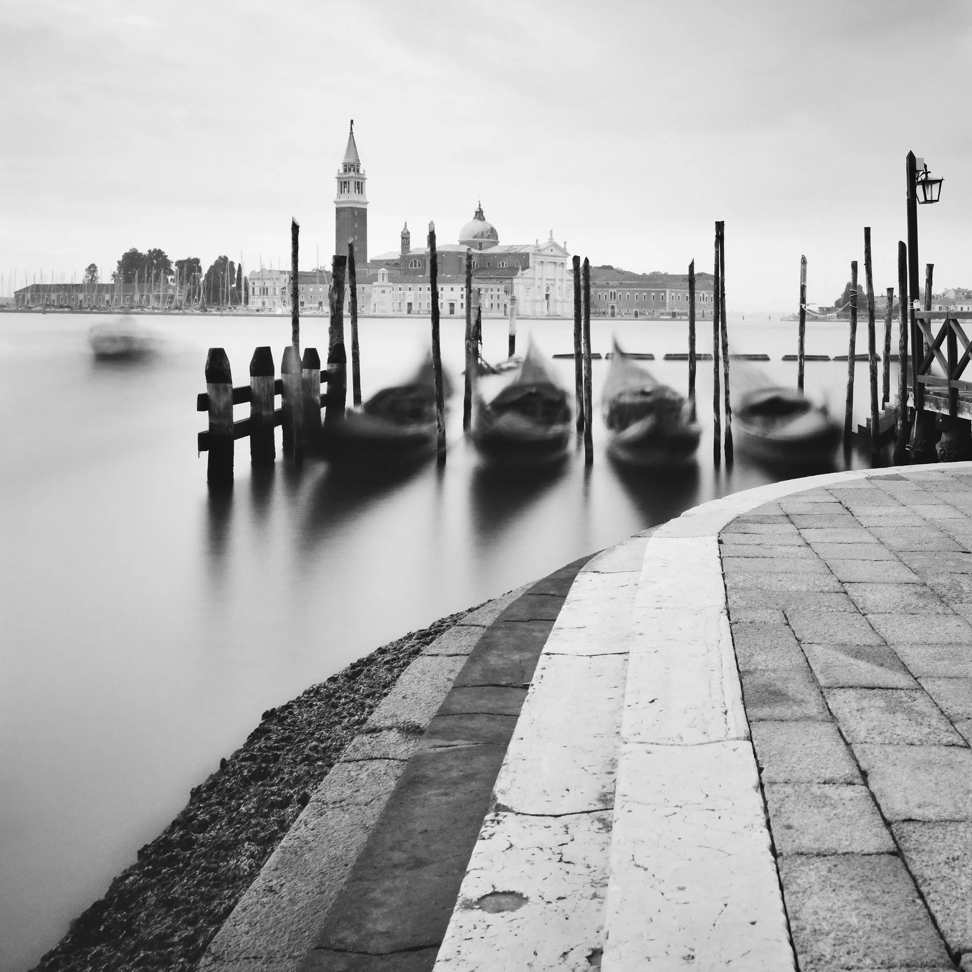 Basilica di San Giorgio Maggiore Study 2 by Gerald Berghammer, detail of blurred gondolas and wooden mooring posts in Venice.