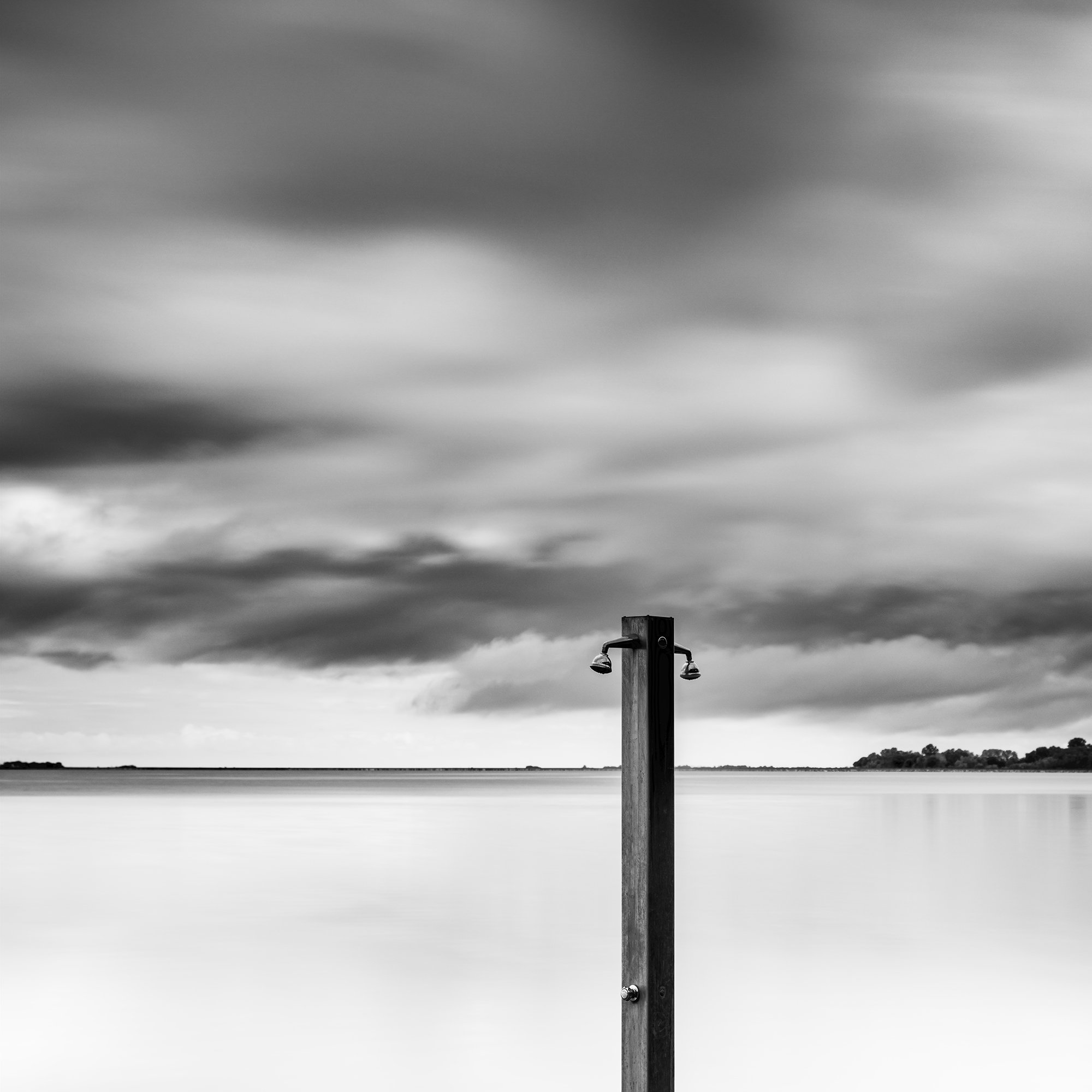 Detail of Beach Shower in a Storm – minimalist black-and-white seascape photograph from Tuscany, Italy, by Gerald Berghammer.