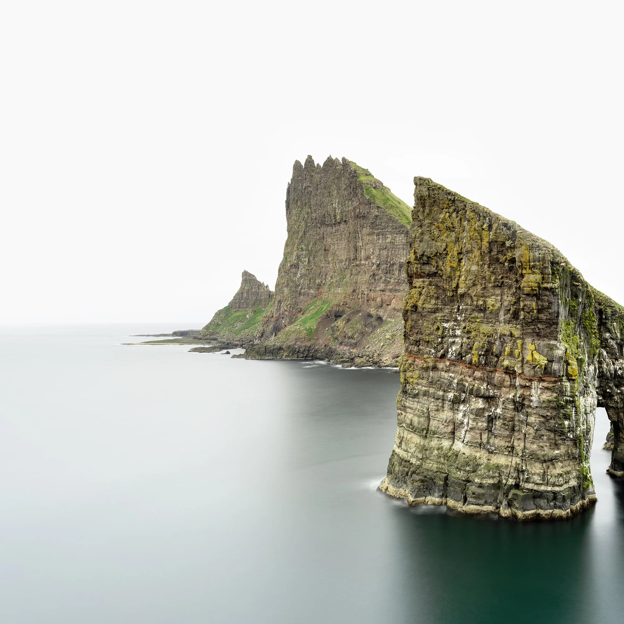 Close-up of the Drangarnir Sea Arch Panorama colour fine art print, showing cliffs and calm water